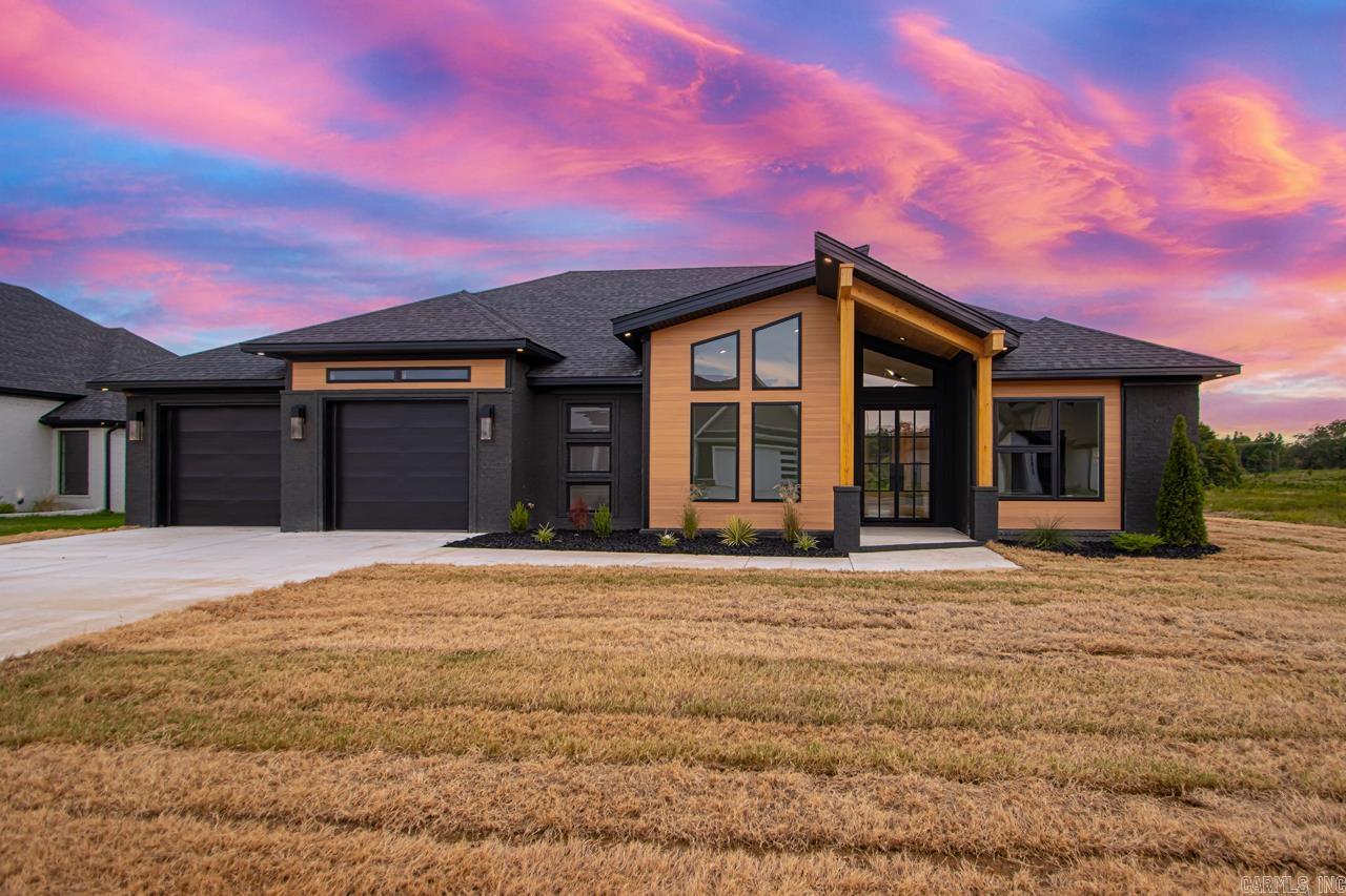 Step into this beautifully designed 4-bedroom, 3-bathroom home where every detail is thoughtfully curatedāfrom the 10-foot ceilings to the designer finishes throughout. At over 2500 sq ft, this home offers an ideal layout for both comfort and style. The chefās kitchen is a true focal point, featuring quartzite countertops, sleek custom cabinetry, and statement pendant lighting that creates an elevated, modern atmosphere. The open-concept layout flows effortlessly into the living and dining spaces, where oversized windows bring in natural light and accentuate the custom ceiling details. Retreat to the primary suite, where you'll find plenty of natural light and a spacious layout, leading into a spa-style bath with upscale touches throughout. Outside, the home boasts bold curb appeal with dark painted brick and architectural metal siding, a covered entry with wood beam details, and a spacious driveway leading to the oversized 2-car garage. Large backyard with covered porch and concrete patio overlooks a beautiful private lake. Nestled in a quiet, new development, this home is perfect for those looking to balance modern design with peaceful surroundings.