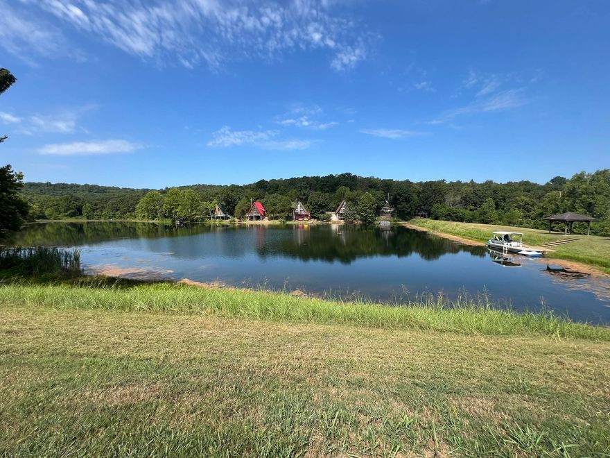 Recreational Property with frontage on Kiwanie Lake, formerly known as Lake Galilee. Potential RV Park/Air BnB cabins or build your dream home it is currently used as a private retreat. The 5.44 acres of land is serviced by Entergy Electric and 2 Highland water meters. There are 15 camper pads (10x20), 3 have 50 AMP service, 7 have 30 AMP service, 3 have septic risers and there is a dump station near the 2022 installed septic system. Two frost free hydrants, set such that they can serve multiple pads, 3 Pavilions and a pontoon boat utilized as a floating dock. Park area also has 2 fenced tennis courts and a 20x40 in ground pool in need of some maintenance to be operational. This property is near but not in Cherokee Village, it has a Hardy AR address but is not in the city limits.