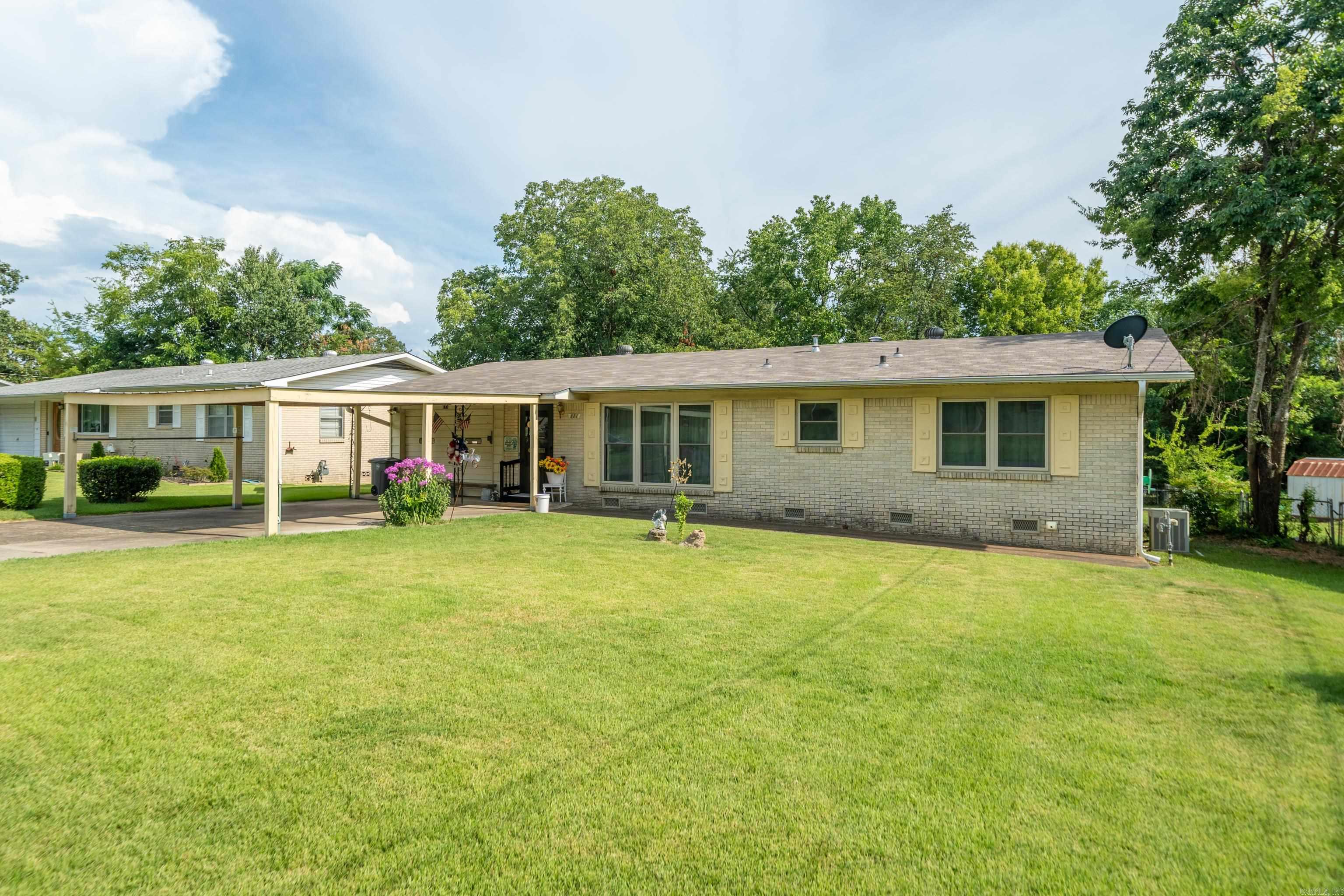 Welcome to this beautifully maintained 2-bedroom, 1.5-bath ranch-style home that combines timeless character with thoughtful upgrades. Situated in a convenient location close to shopping and restaurants, this all-brick home offers comfort, functionality, and plenty of charm. Step inside to find original hardwood floors that add warmth and character throughout the main living areas. The full bathroom features a walk-in shower, and there's an additional half bath for added convenience. Enjoy outdoor living year-round on the screened patio overlooking the fenced backyardāideal for pets, play, or gardening. A detached workshop offers space for hobbies or extra storage, while the one-car garage and two-car carport provide ample parking. Recent updates include new windows and a new roof, ensuring energy efficiency and peace of mind for years to come.
