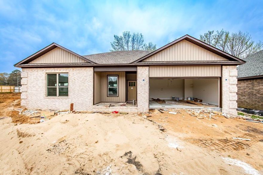 Beautiful new construction home close to shopping and restaurants. This fabulous home showcases a thoughtful design with three bedrooms and two full baths, featuring a split floor plan for optimal comfort and privacy.  The home has vaulted ceiling in living room, 9ft ceilings throughout, custom cabinetry with soft-close doors and drawers. The kitchen is a masterpiece with granite countertops,  tiled backsplash.  NO CARPET, luxury vinyl throughout the entire home.   Covered patio, two car garage and attic storage. Beautiful large walk in tiled shower in master bathroom and double sinks. The seller has also added gutters.  This neighborhood is gated. Yard maintenance is included in the monthly POA dues.   Please contact listing agent for more details or for a private showing.  *** SELLER WILL PAY UP TO $4,000.00 IN CONCESSIONS Home is almost completed.  Don't miss out on this one