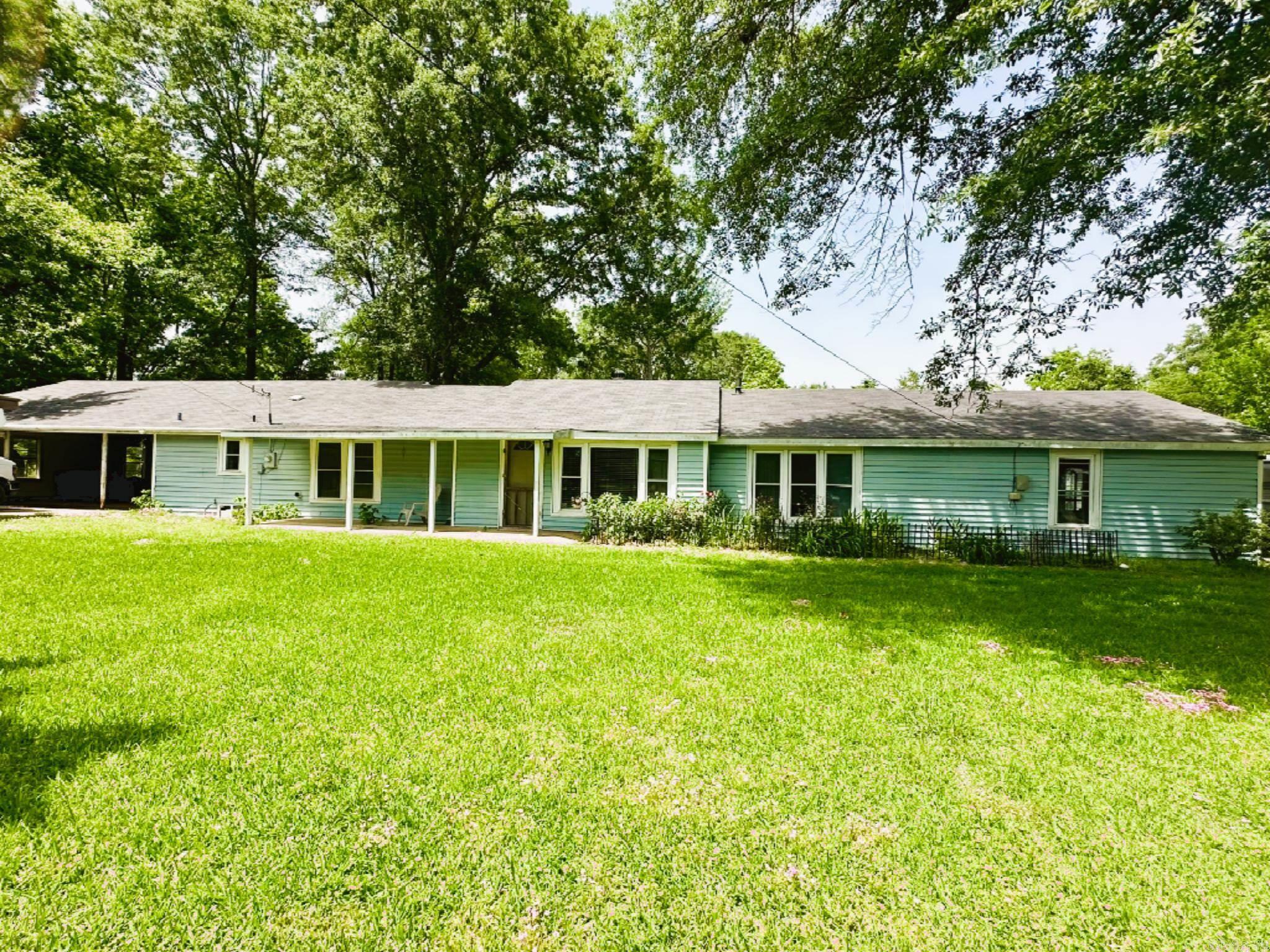 Perfect for a large extended family featuring a house and a mobile home. 212 McMahan is an older home with 2,284 sq feet. Enclosed garage - bonus space, office, living room, dining room, laundry room that has a shower, toilet and sink. Home has three bedrooms and a shared hall bathroom. Also, a roomy screened in back porch. Roof is 5 years old. 208 McMahan is a 1996 mobile home that has 1,960 sq ft, front porch and side porch. Three bedrooms/two bathrooms, office, living room, dining area/kitchen. Open concept. Both homes sit on a little over 2 acres. Includes two carport sheds, metal building and a shop - fully fenced in yard.