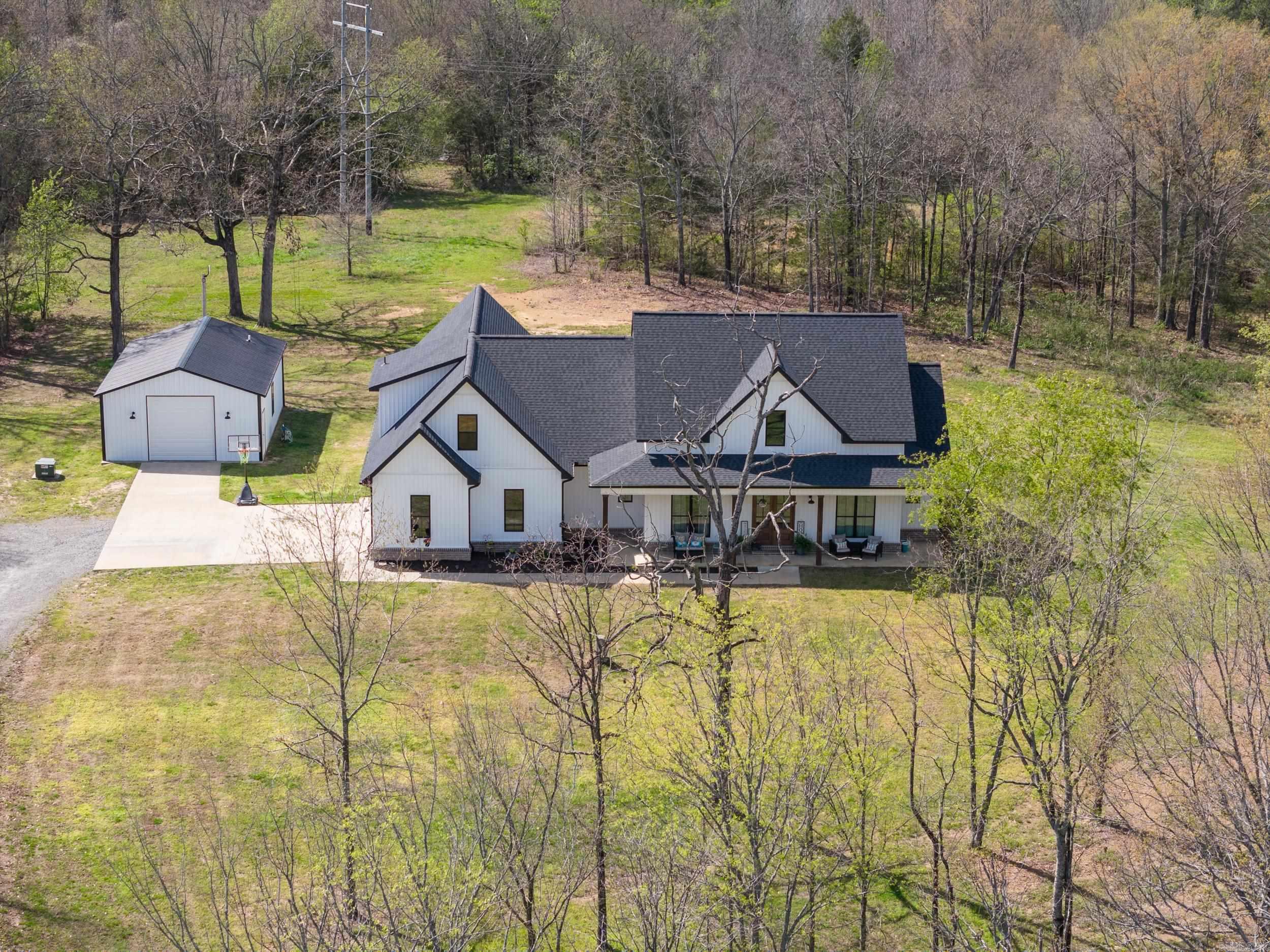 Back on the market NO FAULT OF THE SELLERS! No inspection has been completed yet. Beautiful custom-built home on 8.4 acres was built in 2020. This 2961 sq ft, open concept floor plan has 4br or 3br/office plus an upstairs bonus that could serve as an additional 5th bedroom, 3 full baths, and a large 2-car garage. A kitchen that's a Che'f dream, with a large granite island breakfast bar, and a walk-in pantry with ample cabinetry. Enjoy meals in the eat-in kitchen area or entertain guests in the separate dining room. Stunning primary bath features shiplap walls, soaker tub, glass walk-in shower, vanity space with custom cabinetry and giant master closet with built-ins. Luxury vinyl flooring throughout that is scratch-proof and easy to maintain. Back porch has tongue and groove wood vaulted ceiling. Includes a 24'x36' FULLY INSULATED SHOP, complete with plumbing and electric, includes a bathroom with shower, washer/dryer/refrigerator hookups. There is nothing else like it on the market currently! Schedule a tour today!