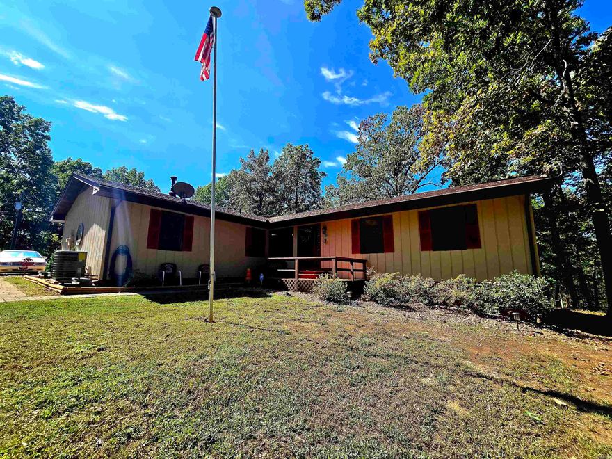 Discover your Ozark retreat with stunning year-round views of Lake Norfork from this beautiful 3-bedroom, 2.5-bath home on 10 acres M/L adjoining the government strip. A gentle slope leads to the Corp line, with easy access down a quiet gravel road and a boat launch less than 10 miles away. Inside, enjoy freshly painted interiors and a spacious kitchen with custom cabinetry, new countertops, and a large island with all appliances included. Recent updates include a new roof, wiring, pressure tank, hot water heater, refrigerator, and dishwasher for peace of mind. Relax by the cozy pellet stove or unwind on the back deck and take in unforgettable Ozark sunsets. The property also features a whole-house fan, attached garage, and a 2-bay shop with loft ideal for hobbies or storage.This home perfectly blends modern comfort with the natural beauty of the Ozarks. Listed at $449,000 make your lake view dream home a reality.