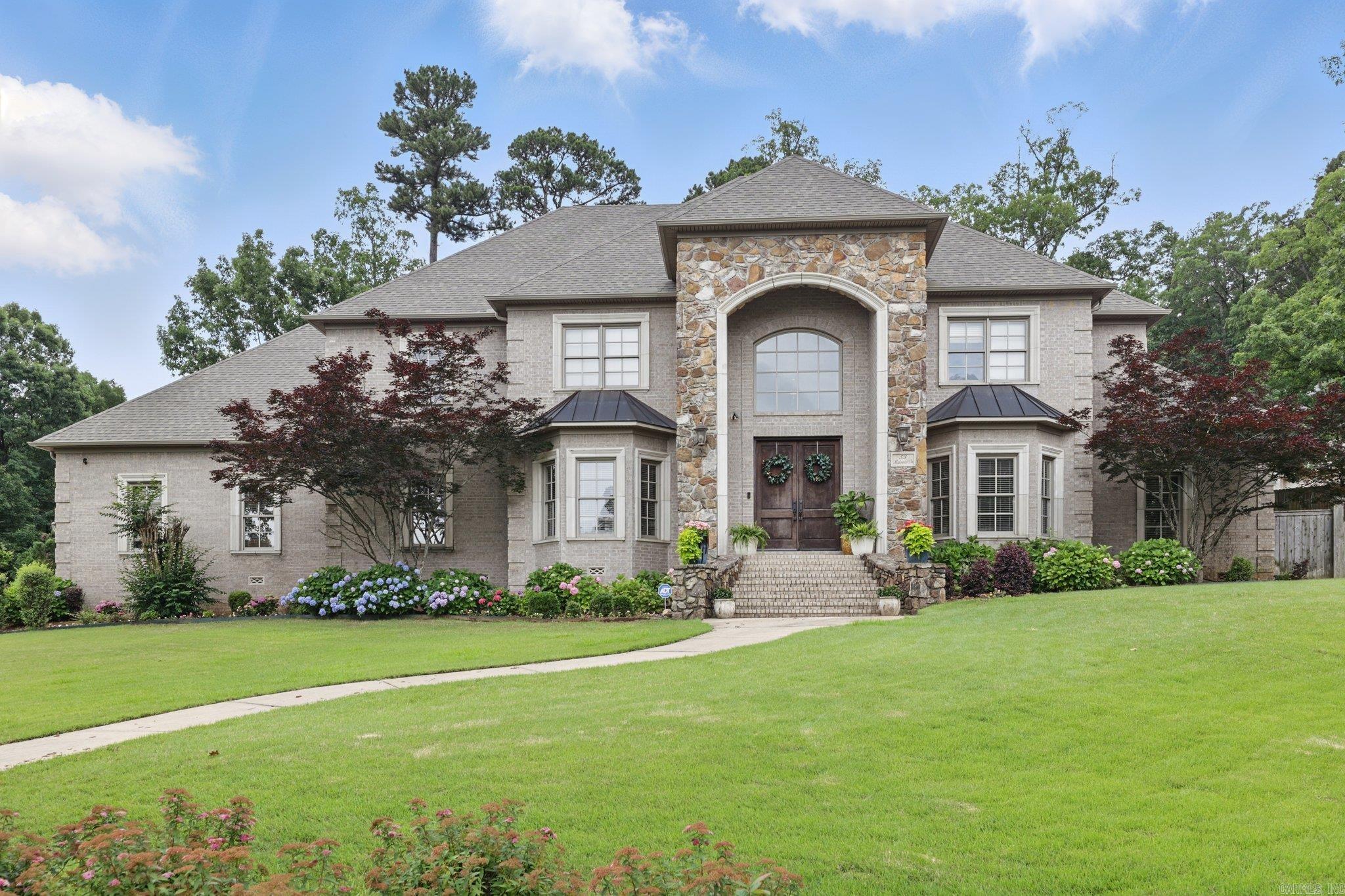 Step into Luxury... The Maisons in Chenal Valley welcomes you to this traditional home that sits on almost a half acre corner lot with professional landscaping and well maintained lawn. This stunning custom home greets you with 20 foot ceilings as you enter the grand foyer entrance. The Primary suite with sitting area on the 1st level offers privacy and one-level living with all the other bedrooms upstairs with ensuite bathrooms and large closets. The 1st floor also boast great entertaining space with open living / dining, the kitchen open to the hearth room and a private office while upstairs also has its own entertainment room with a complete theater system and wet bar. Enjoy the mountain views while conveniently located to shopping & dining. Come see what 53 Maisons has to offer....