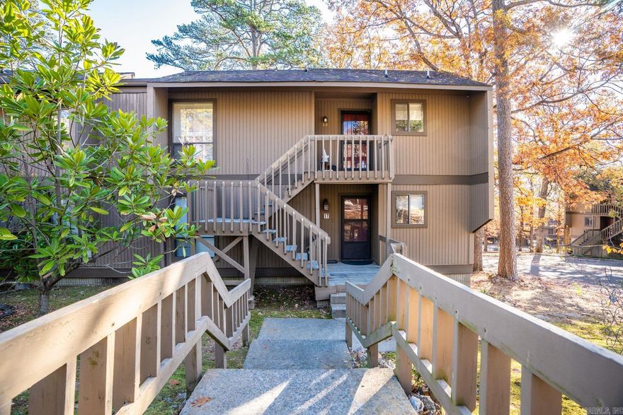 Wonderful condo in a great location...ground level and on the end.  Beautiful hardwoods throughout the home with tile in the bathrooms. The kitchen has been updated with granite, a farmhouse sink and stainless appliances.   Gorgeous custom cabinetry in the family room and kitchen.  A large pass through window opens the family room to the kitchen.  Solid surface countertops in both bathrooms.  Custom lighting and crown molding have been added.  Popcorn has been removed from ceiling, updated doors and door knobs.  Two covered decks provide a great place to entertain or just unwind.  Easy walk to the condo pool.  Condo association pays for each owners fireplace to be cleaned and checked every year.  HVAC 5 years old.  Association fee also pays homeowners water and sewer, pest control inside and out, exterior maintenance in addition to several other items typically covered by condo association fees. Washer, dryer and stainless refrigerator stay with the property... washer is 2023.