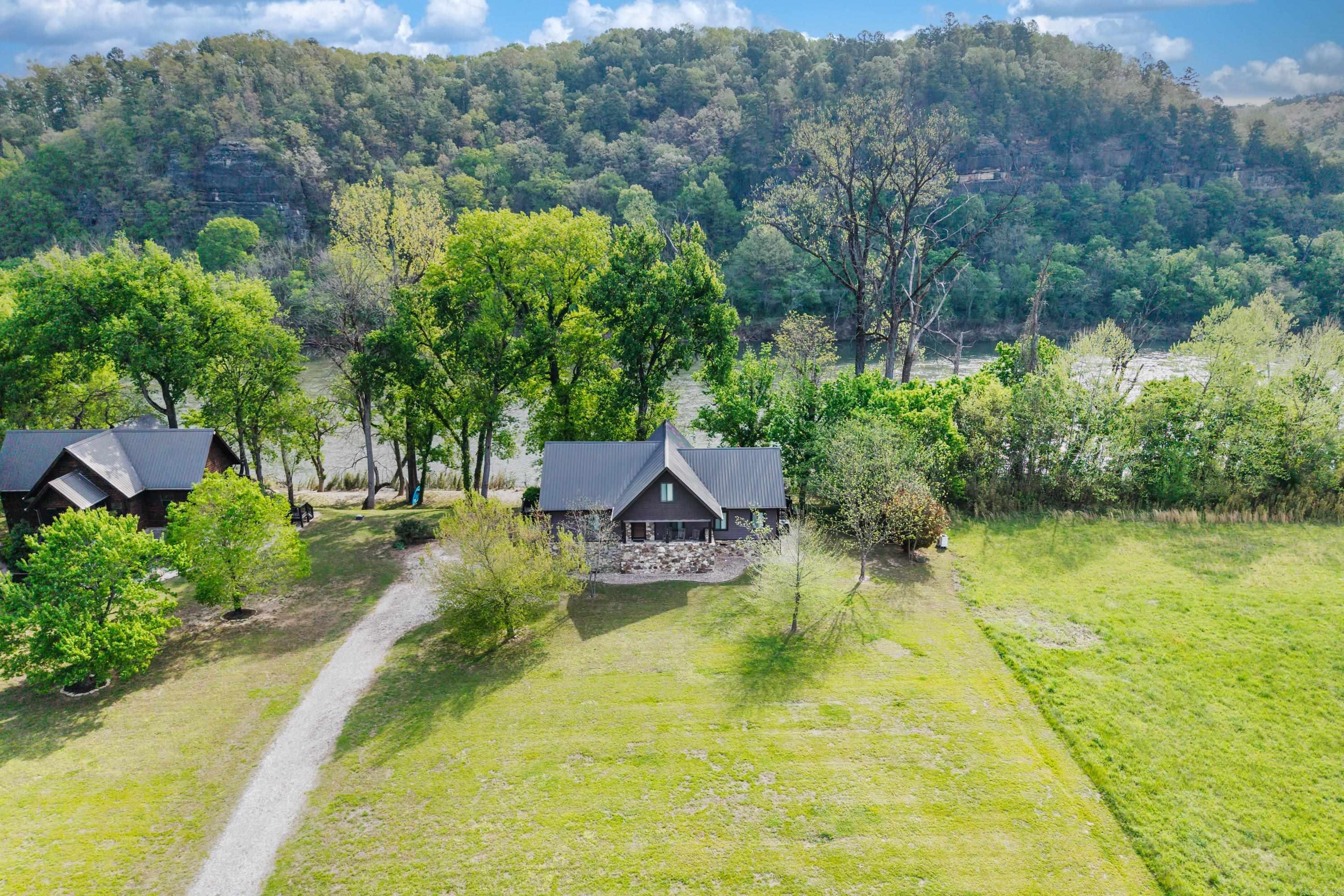 Nestled on 0.97 AC along the serene banks of the White River, this beautiful home offers the perfect blend of comfort, charm, & nature. 3 BRM, 2.5 BTH, open floor plan for both relaxing & entertaining. Front porch has countryside views or enjoy your morning coffee from the screened-in deck overlooking the river. The kitchen has an abundance of countertop space & ample storage. All appliances, including W & D, are included. Most furnishings will be conveyed, making this home truly move-in ready. Utility room, 2nd BRM & full BTH are also on the main floor. Loft includes a sitting area with breathtaking river views, a 3rd BRM, and 1/2 BTH. Outdoors: stone steps lead down to the river's edge, plenty of parking. Storage under the home is perfect for tools or outdoor gear. With a Game & Fish launching area close by, this riverfront gem is a dream come true for outdoor enthusiasts.