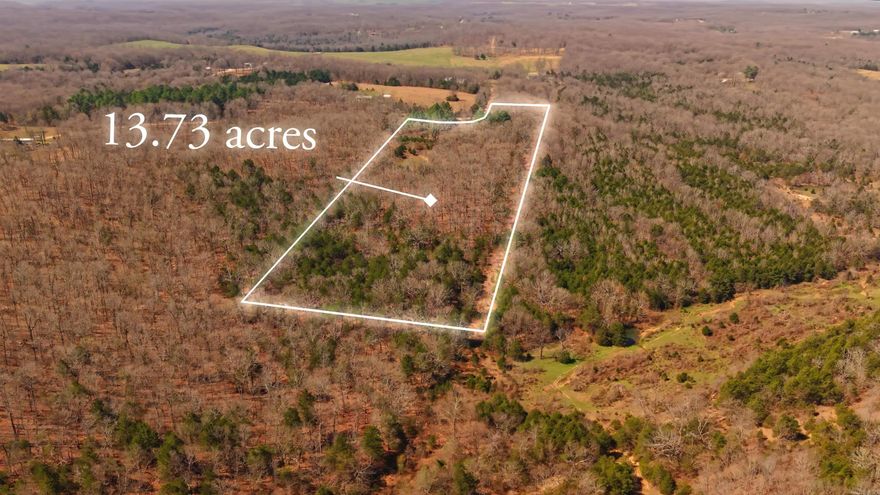 Wooded Acreage with Pond, Utilities, and County Road Frontage  This 13.73 acre m/l property offers a strong balance of privacy and accessibility with county road frontage and easy access, while still providing a quiet, secluded setting. The land is mostly wooded, creating a peaceful atmosphere that is ideal for hunting, recreation, or a private Ozarks retreat. Near the entrance, a level area provides an excellent spot for building your future home, placing a cabin, or setting up a campsite. A scenic pond enhances the property, attracting wildlife and adding both beauty and function. Utilities are already in place with electricity on site and rural water available, making it ready for your plans. Partial fencing is present, and an older wooden shed offers storage or potential for repurposing. Whether you are looking for a hunting tract, weekend getaway, or future homesite, this property offers the space, setting, and potential to make it your own.