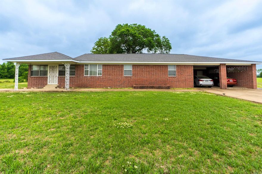 Spacious 4 bedroom, 2 full bath brick home situated on 1.53 acres offering the perfect blend of country living and functional space. This well-maintained property features over-sized living areas, a large kitchen with abundant cabinet and counter space, and multiple gathering areas ideal for everyday living or entertaining guests. The home offers a comfortable layout with generously sized bedrooms, plenty of natural light, and classic charm throughout.  Outside, enjoy the peaceful rural setting with open views, mature shade trees, and plenty of room to spread out. The attached covered parking area provides convenience and additional storage space, while the enclosed sunroom offers a great spot to relax year-round. Whether you are looking for room for a growing family, space for hobbies, or simply a quiet country setting, this property has endless potential.  If you have been searching for a solid brick home with acreage and space both inside and out, this one is worth a look.