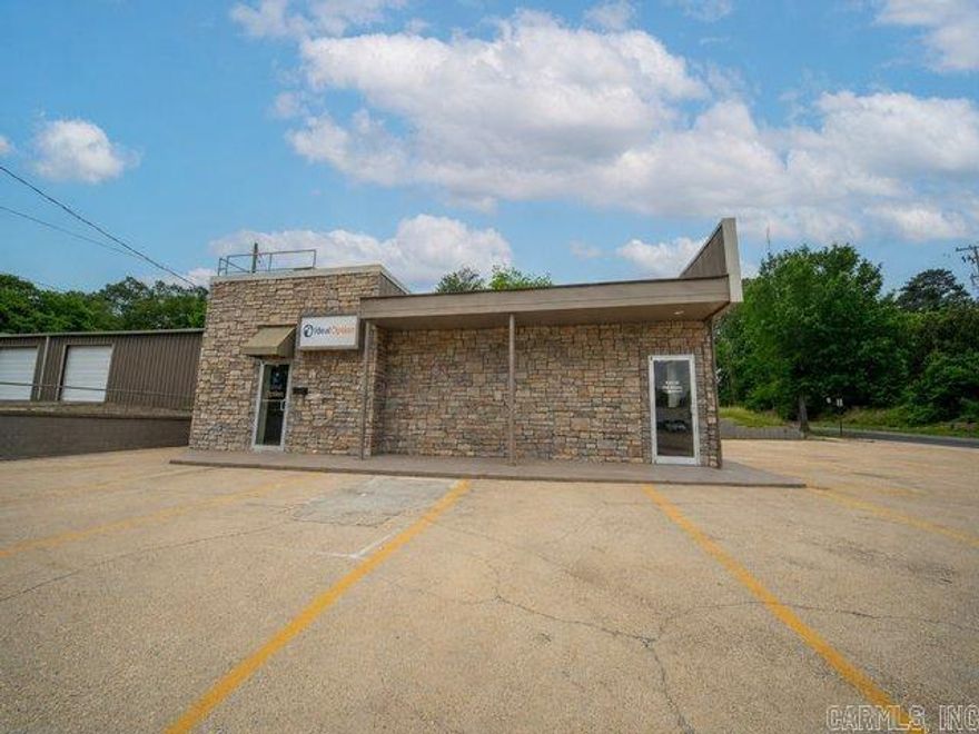 Positioned on a highly visible stretch of East Main, this freshly remodeled commercial building offers the kind of presence and practicality that business owners look for but rarely find at this price point.  With 2,274 square feet of updated office space, this property is set up to support a variety of professional uses...from medical or insurance offices to retail services, financial offices, or small business headquarters. The stone exterior creates strong curb appeal, while the generous paved parking area provides convenience for both clients and staff.  Inside, the remodeled office layout offers flexibility for multiple workspaces, private offices, or customer-facing areas. Two bathrooms add functionality for daily operations, and the layout lends itself well to both owner-occupants and investors seeking a ready-to-use space.  The corner location enhances visibility and accessibility, making it easy for customers to find and access the property. With its solid construction, professional appearance, and adaptable interior, this building is well-positioned to support business growth for years to come.