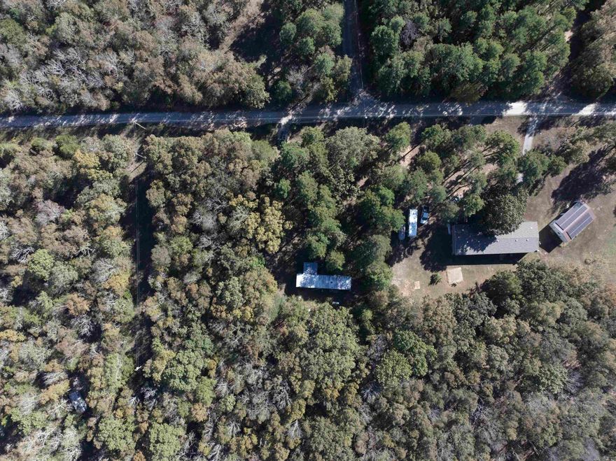 This 3-acre parcel in the peaceful countryside, where tranquility meets opportunity is the perfect spot for your dream home build. With water, septic, and electricity already present on the property, you can start building in no time. Nestled away from the hustle and bustle, this quiet retreat offers a serene escape, with plenty of space for your vision to come to life. Picture yourself sitting on the porch, sipping your morning coffee, as you watch squirrels play in the trees and listen to the gentle rustling of leaves. The property is accessed by a gravel road, ensuring privacy and minimal traffic, making it the ideal spot to unwind and enjoy the beauty of rural living. Mobile home conveys with no additional value to property.