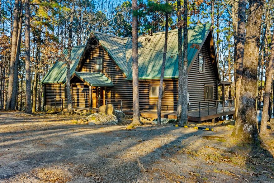 This LAKEFRONT LOGCABIN has a permitted gently sloped walk-path to the water, with a natural beach smooth enough for boat pull-up. Extensive exterior improvements have been completed, including fresh paint, new chinking & sealing. The interior has also been professionally chinked & sealed, ensuring durability and comfort. The home offers nearly 1,000 square feet of wrap-around decking, designed for year-round enjoyment. Custom Ipe hardwood handrails paired with iron posts and marine-grade stainless cable railings create both beauty and longevity. A Trex under-deck drainage system provides a dry, covered outdoor living area. Inside, lake views greet you the moment you enter. Newly installed upper picture windows, dining room windows & energy-efficient double-pane sliding glass door flood the home with natural light. The kitchen is equipped with a new Whirlpool dishwasher & microwave, new under-counter ice maker, and has a Jenn-Air gas range. Energy efficiency upgrades include a new upstairs Mitsubishi mini-split system, allowing guests climate control. New downstairs HVAC & ductwork, a new 80-gallon electric WH & spray-foam insulated encapsulated crawl space. Fiber-optic internet.