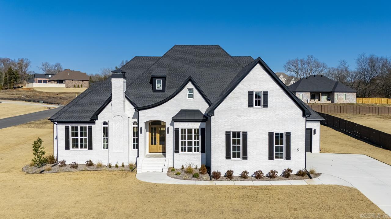 Step into a realm of architectural splendor with this custom-built home, where the craftsmanship is not just seen, itās felt in every meticulously designed space. Soaring 10-foot ceilings stretch throughout the home and immediately captivate you, setting the stage for a true experience. Elegant coffered ceilings create an atmosphere of sophistication, while triple crown molding, hand-crafted fireplace trim, bespoke soft close cabinetry, and luxury flooring blend beauty and functionality, while the lighting features add to its opulence. Granite countertops of stunning quality range throughout the residence, harmonizing with two exquisite fireplaces that anchor the living spaces with warmth and style. Each bedroom is a private retreat, boasting custom bathrooms complete with 7-foot linen cabinets, ensuring ample space and elegance. Convenience and modern living are evident with a wet bar, and kitchenette situated upstairs across from an entertainment room tailor-made for memorable moments. This property spans .86 acres, encompassed by a comprehensive front and back sprinkler system. This home stands as a masterpiece & testament to what can be achieved when no detail is overlooked.