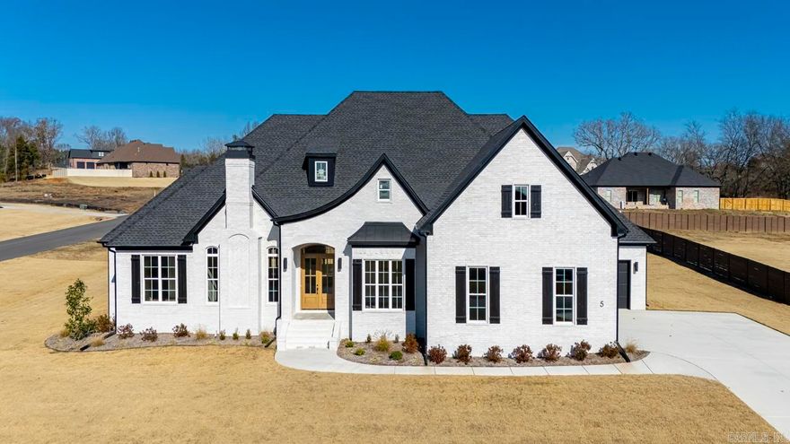 Step into a realm of architectural splendor with this custom-built home, where the craftsmanship is not just seen, it’s felt in every meticulously designed space. Soaring 10-foot ceilings stretch throughout the home and immediately captivate you, setting the stage for a true experience. Elegant coffered ceilings create an atmosphere of sophistication, while triple crown molding, hand-crafted fireplace trim, bespoke soft close cabinetry, and luxury flooring blend beauty and functionality, while the lighting features add to its opulence. Granite countertops of stunning quality range throughout the residence, harmonizing with two exquisite fireplaces that anchor the living spaces with warmth and style.  Each bedroom is a private retreat, boasting custom bathrooms complete with 7-foot linen cabinets, ensuring ample space and elegance. Convenience and modern living are evident with a wet bar, and kitchenette situated upstairs across from an entertainment room tailor-made for memorable moments. This property spans .86 acres, encompassed by a comprehensive front and back sprinkler system. This home stands as a masterpiece & testament to what can be achieved when no detail is overlooked.