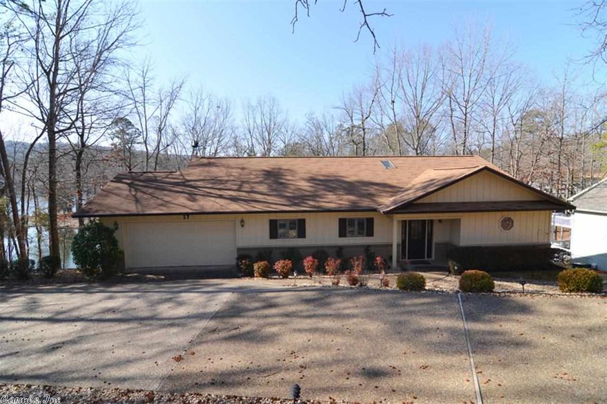 DeSoto lakeshore! Priced to settle estate!  Seller may assist with buyer closing costs. A custom home w/open floor plan and high ceilings.  Walls of windows maximize dramatic lake views.  Great room, Master Br/Ba, kitchen, sun room and laundry on main level. Lower level has family room, guest bedroom and bath.... perfect for visitors. Versatile craft room as well.   Large decks up and down.  Private deck with hot tub off master. Freshly painted inside.  Roof  2006. Well kept grounds with low maintenance.