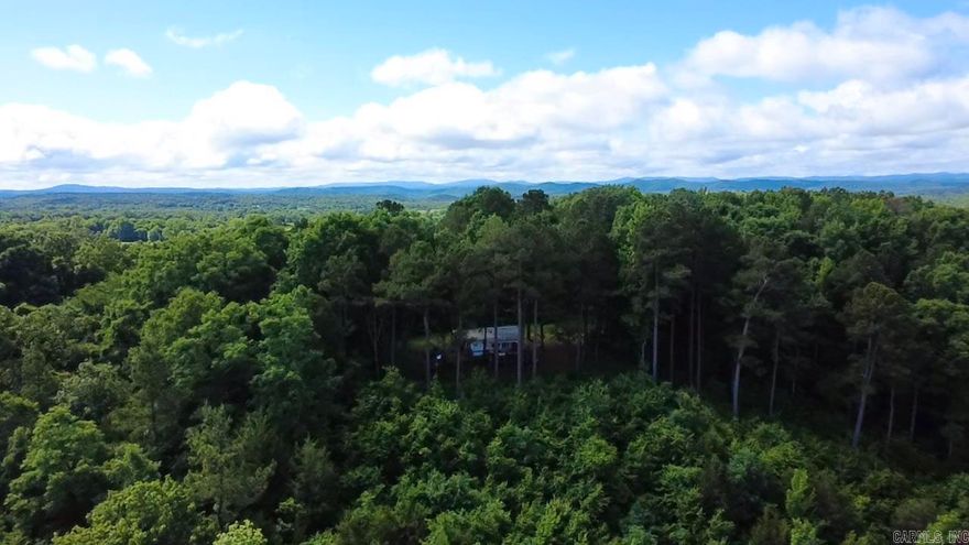 10 wooded acres with gorgeous mountain views! This is your private oasis away from it all!  Plenty of features make this property ready for your outdoor plans: ramp to unload your 4x4, cover for your generator, rain barrels for water supply, 125 yard clearing for the deer field, and more! Just minutes away from the National Forest and ATV trails, this could be your hunting camp or base camp for all things outdoor!  Or just sit and enjoy the view! The 2007 model 18ft camper trailer, deck, and all personal property is included with the sale.