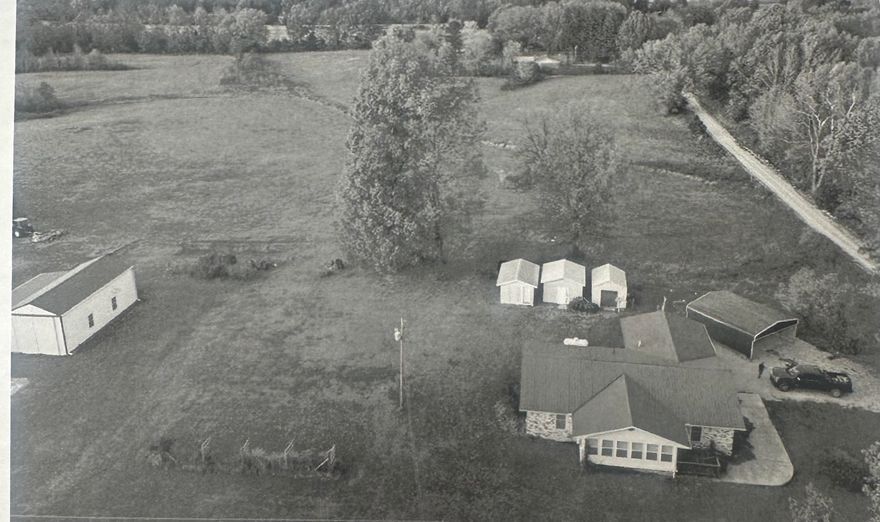 This property is 0.75 miles east of Saffell, Arkansas, (8 miles south of Strawberry and 9.5 miles north of Cord). The home is on the north side of State Highway 361 at the intersection of Highway 361 and Lawrence County Road 343. This property includes 1.2 acres of land. The 1589 square foot brick home was constructed in 1972. It has a relatively new metal roof. In addition to the home, there are 3 small storage sheds (one with electricity), a small pole barn, an attached two car carport, a new detached two car carport and a 1533 square foot shop building constructed on a concrete slab.