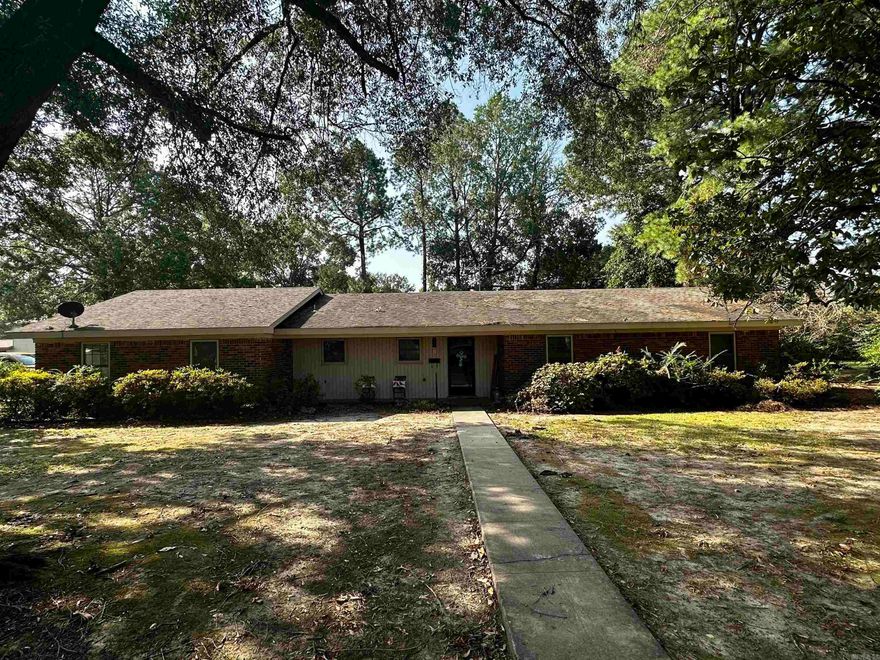This fully brick home offers 3 bedrooms, 2 bathrooms, and 1,809 square feet of living space. It's nestled in a spacious corner lot within a charming, well-established subdivision in the heart of Lonoke. It's conveniently situated less than half a mile from the new school additions and enjoys a central location in town. The property boasts a bonus room, currently utilized as an office, which has its own access via the garage. Inside, you'll find generously sized rooms with new flooring, an updated kitchen, and updated light fixtures throughout. To sweeten the deal, a hot tub is included with a strong offer.