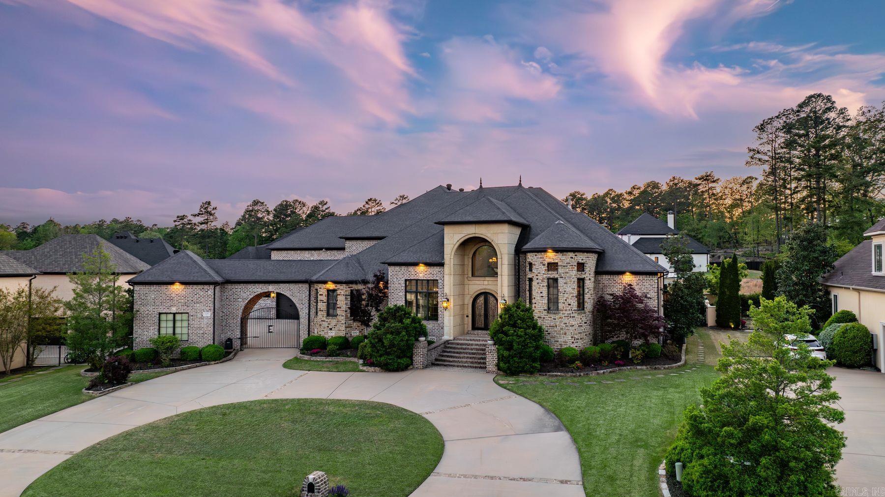 Welcome to 106 Orle, where Tuscan-inspired elegance meets relaxed luxury in one of Chenalās premier gated neighborhoods. Step into the grand two-story foyer with hand-painted frescos, giving an artistic and warm touch to the living spaces. This chefās kitchen is made for entertaining,with double islands, premium appliances, and a wet bar. A private main-level guest suite offers a space for visitors, complete with its own sitting area and ensuite bath. The primary suite features a separate living area perfect for a wellness room, office, or library highlighted with a three-way glass fireplace . A serene spa like bath and dual oversized closets add to the abundance of this suite. Upstairs multiple spaces offer endless possibilities, including two guest suites each with their own ensuite bathroom, a theatre room with a built-in bar, a second private office with an attached covered balcony, and a work out or playroom. Your private outdoor oasisāwith a full kitchen, hot tub, and peaceful fountain is the perfect place to entertain. And for golf lovers, drive your cart directly from your garage to private access of the 18th hole of the Bear Den Course at Chenal Country Club.See remarks