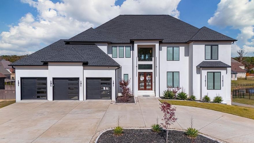 Exquisite 6,000 sqft dream home in Benton's prestigious Hurricane Lake Estates community suited for hosting and entertainment. This impressive property features 5 beds, 6 full baths, offering ample space for family and guests. At the heart of the home is an open kitchen, complete with a hidden butler's pantry, custom cabinetry, stainless steel appliances, and modern fixtures. An interior balcony overlooks the expansive main living room offering 22' ceilings, enhancing the open-concept design. The owner's suite is a haven of luxury with a huge walk-in shower and tub combo, accompanied by a generous closet. The home includes a fully finished walk-out basement, whole-house generator, storm shelter room, theater room, sauna, and a convenient laundry chute. It is equipped with a lawn sprinkler system and an oversized three-car garage. Enjoy breathtaking views of Hurricane Lake from the rear wrap-around balconies. The property is located in a gated community with access to Benton's A-rated school district and amenities such as a community pool, tennis and pickleball courts, a playground, and a clubhouse providing sophisticated living in a premium location. Welcome home.
