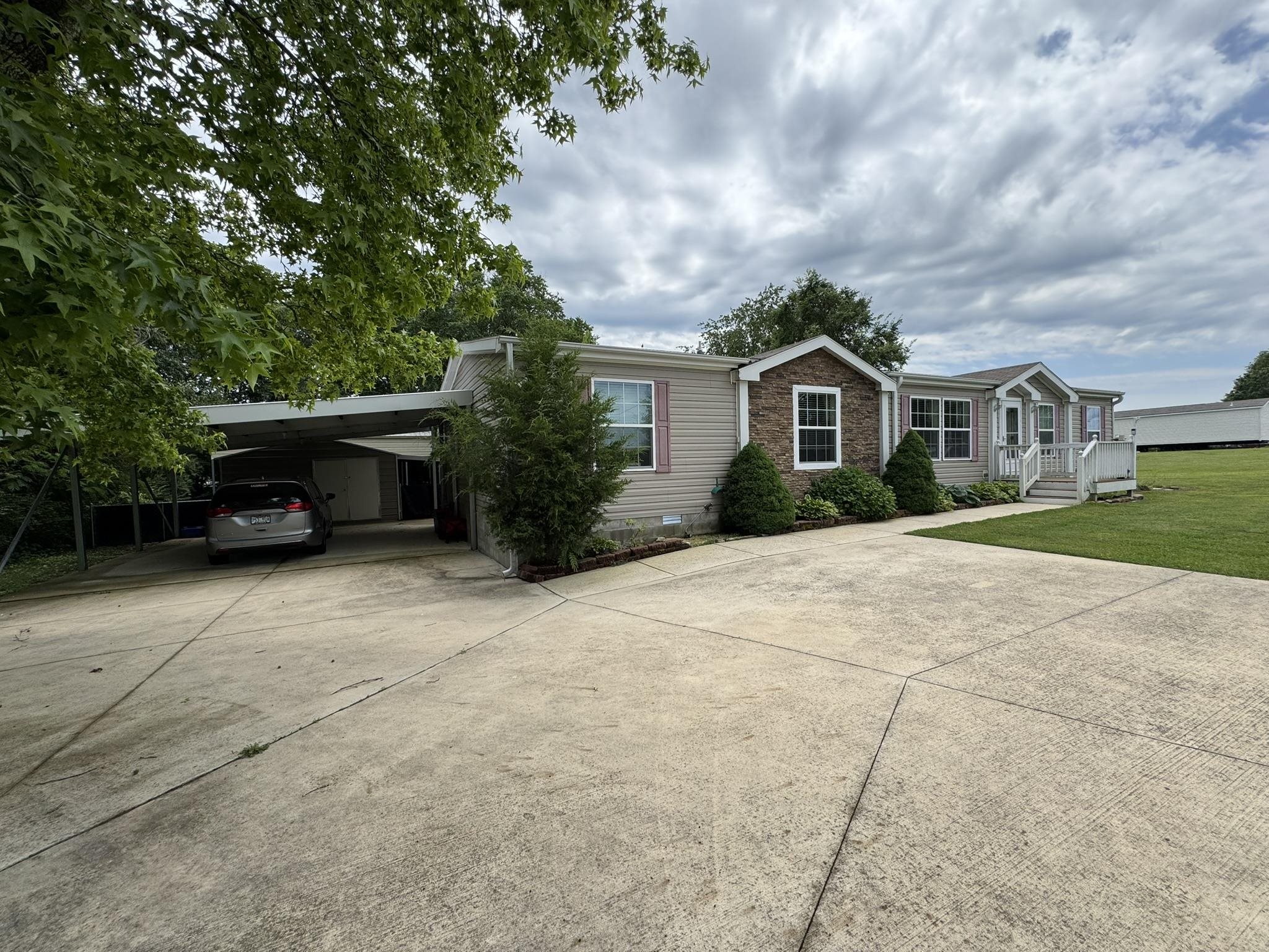 AMAZING FIND!! THIS 3 BEDROOM/ 2 BATH CUSTOM BUILD HOME SITTING ON A LARGE .61 AC/ML LOT WILL AMAZE YOU WITH ALL THE EXTRAS THAT YOU MIGHT NOT FIND WITH A SIMILAR HOME. OUTSIDE YOU WILL FIND A VIEW OF THE COUNTRY FROM THE FRONT PORCH, A LARGE 2 CAR ATTACHED CARPORT, A METAL STORAGE/ WORKSHOP BUILDING WITH AN ATTACHED LEAN TO, A FENCED IN BACK YARD, PLUS AN RV CARPORT, WITH ELECTRIC HOOK UPS, & WHOLE HOUSE GENERAC GENERATOR, INSIDE YOU WILL ENJOY THE OPEN FLOOR PLAN, WITH A GAS LOG FIREPLACE, WELL EQUIPED KITCHEN WITH AN ISLAND. LARGE LAUNDRY ROOM WITH SINK & STORAGE, THE MASTER BEDROOM HAS AN OVERSIZED WALK IN CLOSET, & BATH WITH HIS & HER SINKS, SEPARATE COMMODE ROOM, AND A LARGE WALK IN SHOWER, WITH DUAL SHOWER HEADS & SIT-DOWN BENCH. RELAX IN THE BACK WITH THE LARGE & COVERED SCREENED IN DECK. THIS ONE IS ONE OF THE BEST EQUIPPED & MOST SPACIOUS HOMES YOU WILL FIND IN A 55 & OLDER RETIREMENT COMMUNITY IN THE AREA. WELL WITH A LOOK.