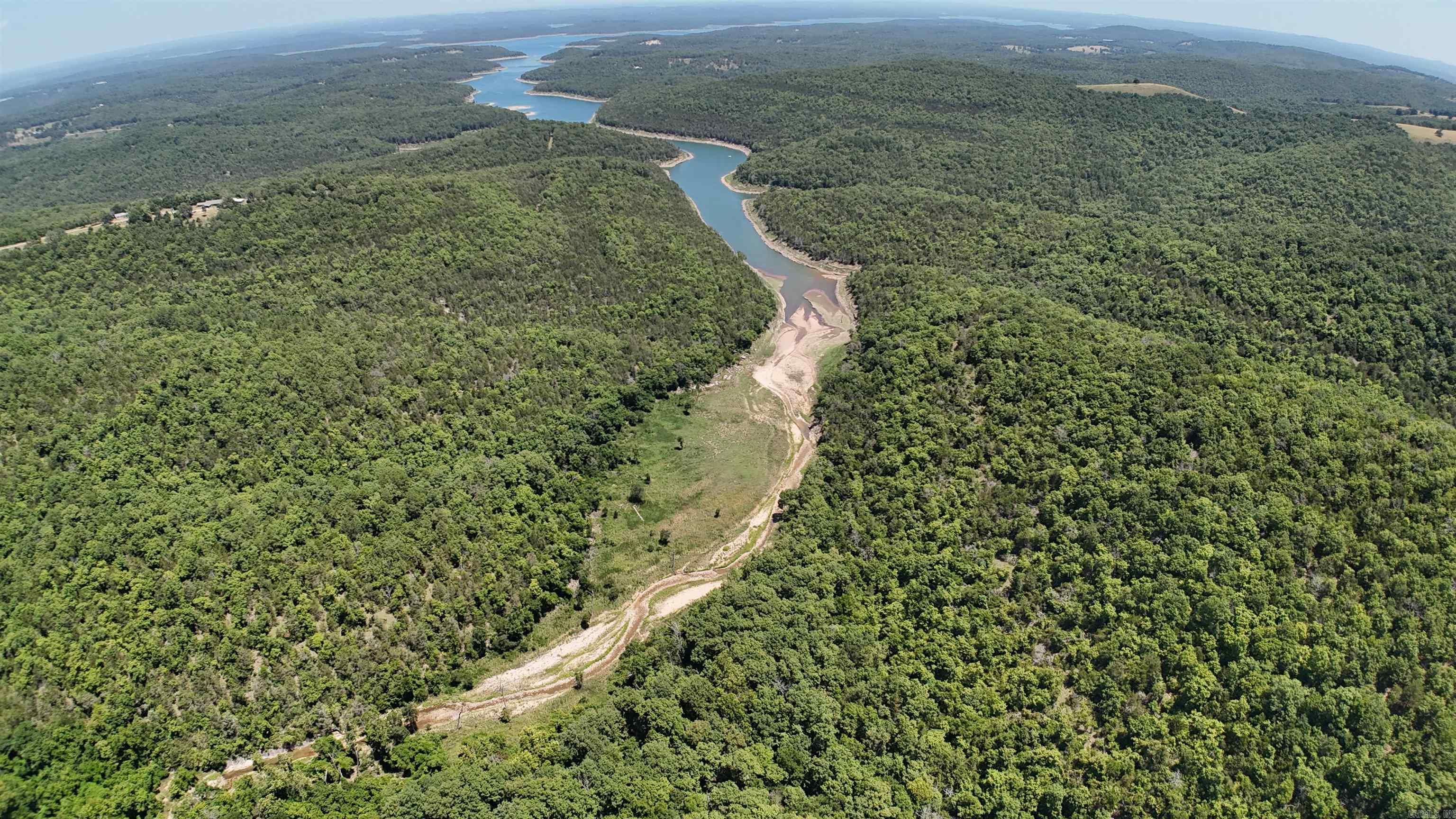 10 acres m/l for sale in the Ozark Mountains in rural Marion county, Arkansas with no deeded access. The property has a good mix of hardwoods and backs up to the US Corps of Engineers federal land. This property would make a great Ozark Mountains off-grid hunting retreat. The new buyer will be responsible for obtaining any needed easement(s). Priced to sell quickly, don't miss this opportunity. Call today!!!