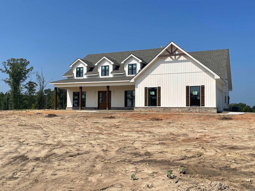 New construction with long front porch on two acres. Beautiful open floor plan with vaulted ceilings in living area, fireplace with built-in  cabinets. Kitchen has huge bar with granite countertops and large walkin pantry.