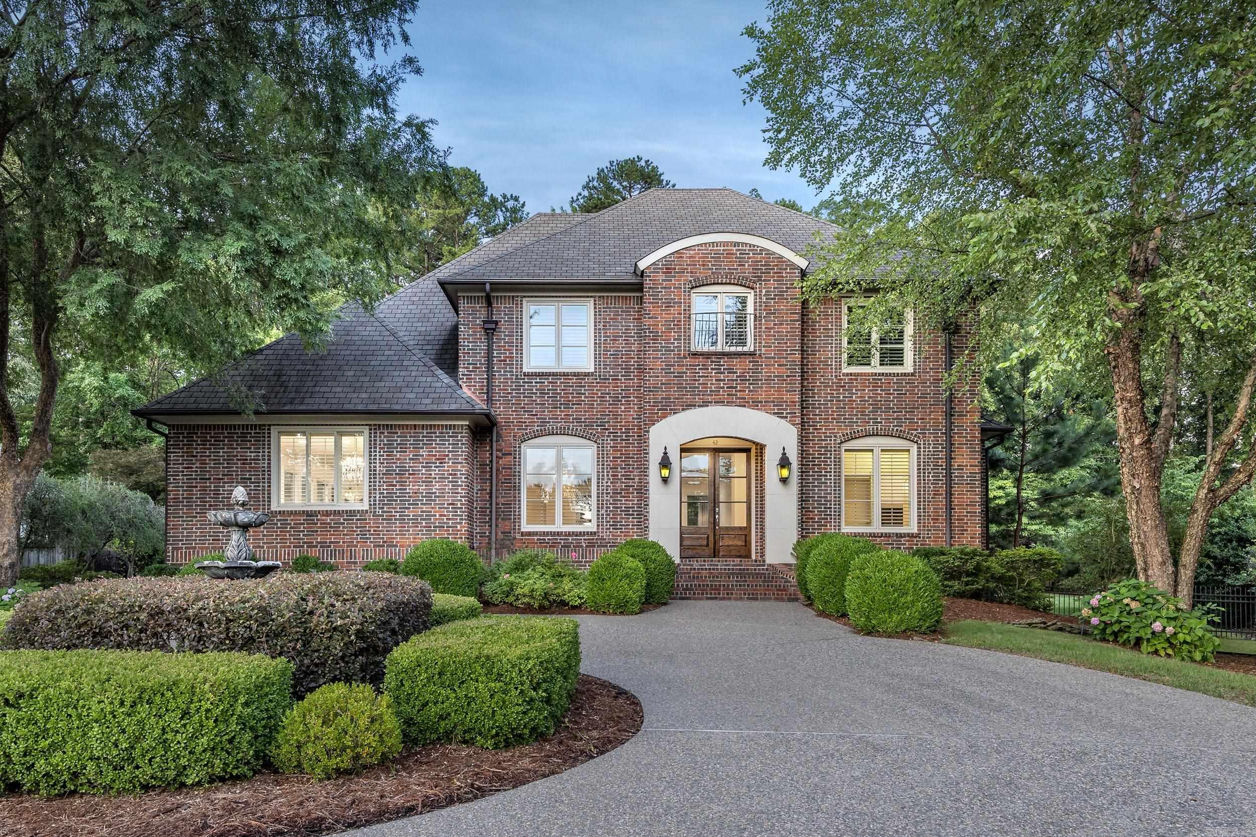 Stunning 4-bed, 3.5-bath home in one of Chenal’s most desirable neighborhoods with golf course views and refined finishes throughout. This custom home features soaring ceilings, a grand staircase, and elegant wood floors. The gourmet kitchen includes double ovens, gas cooktop, island, and abundant cabinetry—perfect for entertaining. The spacious living area centers around a stately double-sided fireplace and flows into a light-filled sunroom with backyard views. The oversized, main level primary suite includes screened porch access, double-sided fireplace, soaking tub, and walk-in shower. Three additional bedrooms upstairs offer options for family, guests, office/craft room, or entertainment area. Outside, enjoy a tranquil waterfall feature, fully fenced yard, and expansive patio space ideal for relaxing or hosting. Additional features include a 3-car rear-entry garage, built-ins, and updated lighting. Conveniently located near golf, dining, shopping, and top-rated schools. This home blends comfort, elegance, and lifestyle in the heart of West Little Rock. Schedule your private showing today! BONUS- New downstairs HVAC unit!
