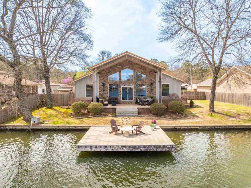 Welcome to the perfect lake retreat, for you and your guests - This beautiful lake house, complete with a charming lake side cottage, offers breathtaking views, private lake access and endless opportunities for relaxation and recreation.  The main house features a gourmet kitchen with high-end appliances, a butler’s pantry for added convenience, and an open-concept living space with soaring ceilings and stunning water views.  A cozy loft provides extra space for an office, lounge, or additional sleeping area.  Step outside to your private swim dock, perfect for sun-soaked afternoons and water adventures.  The cottage provides a private oasis for your guests, or could be used as rental income with 2 bedrooms and 1 bath.  The back deck of the cottage is perfect for entertaining or tossing your fishing line.  The property also features a detached 2 car garage, with plenty of room for vehicles, storage or lake toys.  Behind the garage, you will find the 1 stall boat dock, equipped with a boat lift. Whether you're looking for a dream home, a vacation retreat, or a lucrative investment property, this stunning lake house with a separate guest cottage offers endless possibilities.