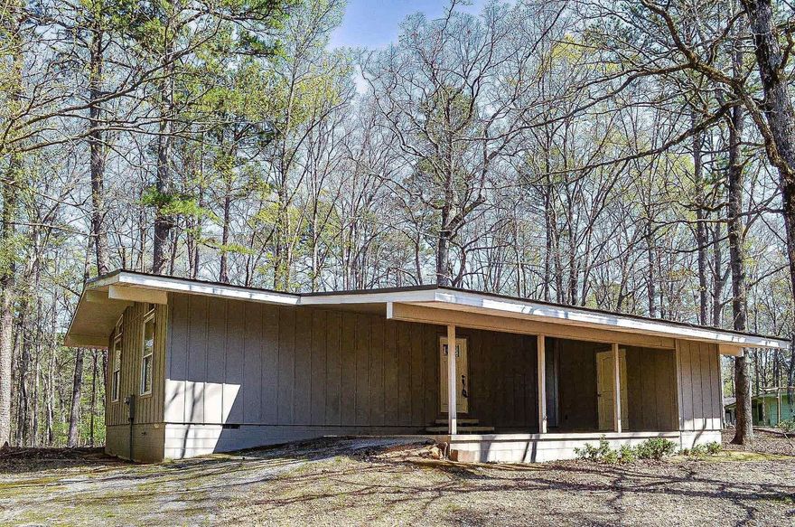 Surprise......the build date may say 1971 but this charming 2 bedroom 2 bath home has been totally renovated. Redesigned kitchen and both baths. Upgrades include granite counters, custom cabinets, wood floors, upgraded appliances, energy conscious windows and even a metal roof. Transoms above the French doors to the deck. Vaulted ceiling, upgraded ceiling fans and electrical fixtures. Hot Springs Village Property Owners Association has a new member buy-in fee of $2,000.00 due and collected at closing.