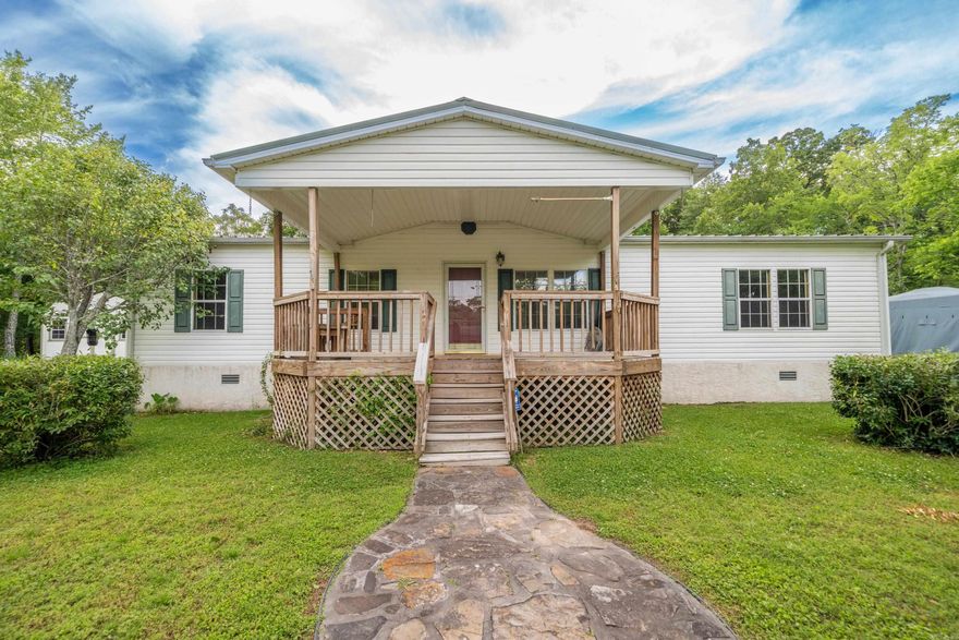 Well-maintained triple-wide manufactured home on almost half an acre with fresh paint and new flooring throughout. This home offers 3 bedrooms with a split floor plan, featuring a private primary suite. The spacious kitchen flows into the living area with a cozy fireplace. Enjoy the front porch that features a built-in bench. Two carports and a backyard storage shed provide added convenience.  **Professional Photos Coming Soon