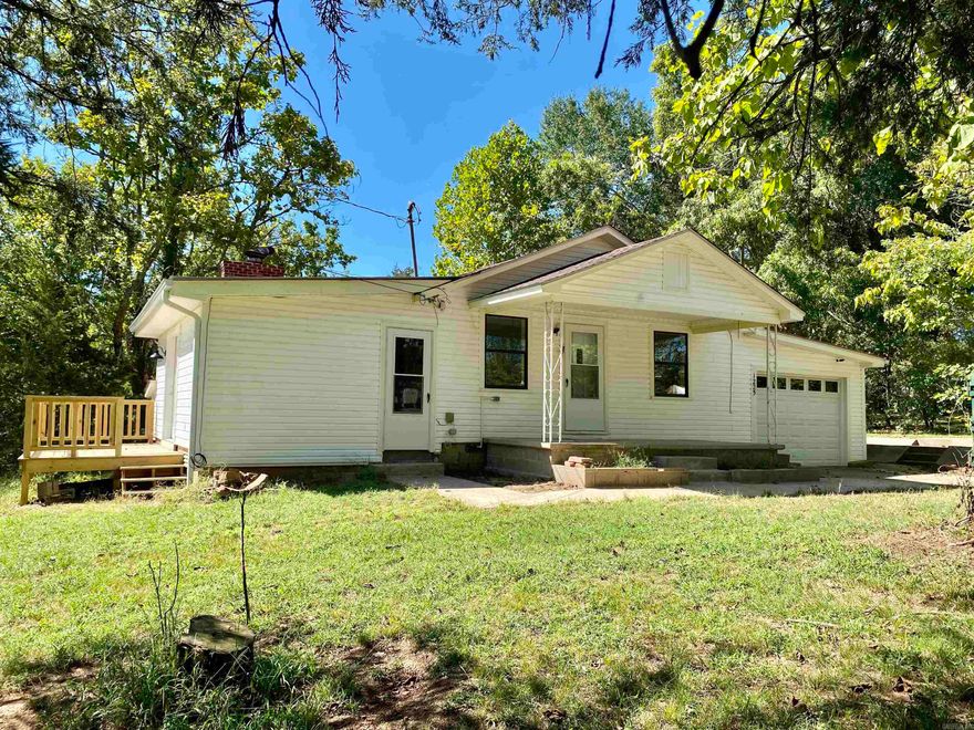 Inviting & charming country style cottage recently updated w/ new flooring, paint, fixtures, baths, & kitchen.  Lovely setting on a 1 acre lot covered in established shade trees with no rear neighbor.  Many outdoor living spaces:  front & rear covered porches & a side sun deck.  Open kitchen/living area w/ attached sunken den w/ rock wood burning FP.  Large kitchen w/ an abundance of cabinetry and a breakfast bar.  Also, offered with a 1 Yr. Home Warranty for buyers peace of mind covering all major appliances & HVAC System.  Attached storm shelter off of den.  Detached shop/garage w/ many storage cubbies.  Ask your agent about $0 down financing options on the lovely residence in Lamar.