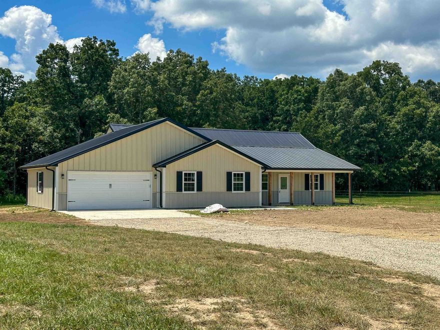 Enjoy peaceful country living and the joy of owning a self-sustainable, wooded, 5 acre barndominium ranchette within minutes to Ozarka College, Ash Flat Ballpark, shopping, and more! With 2,020 sqft of living space, this 4 bedroom, 3 bath black and white steel home, features a 620 Sq ft deluxe guest-suite and finished garage. As you enter this home you will be greeted with a wide open floor plan , vaulted ceilings, a view of the gourmet kitchen with island and granite countertops. Boasting a split floor plan for master bedroom privacy, your master suite includes his and her closets, dual vanities and tray ceilings. Your deluxe in-law/guest suite features a kitchenette, private bath w/ walk-in shower, and sitting area. $7500 in Buyer Incentives from now until the end of August which can be used towards closing costs, upgrades, etc.  Call Today!
