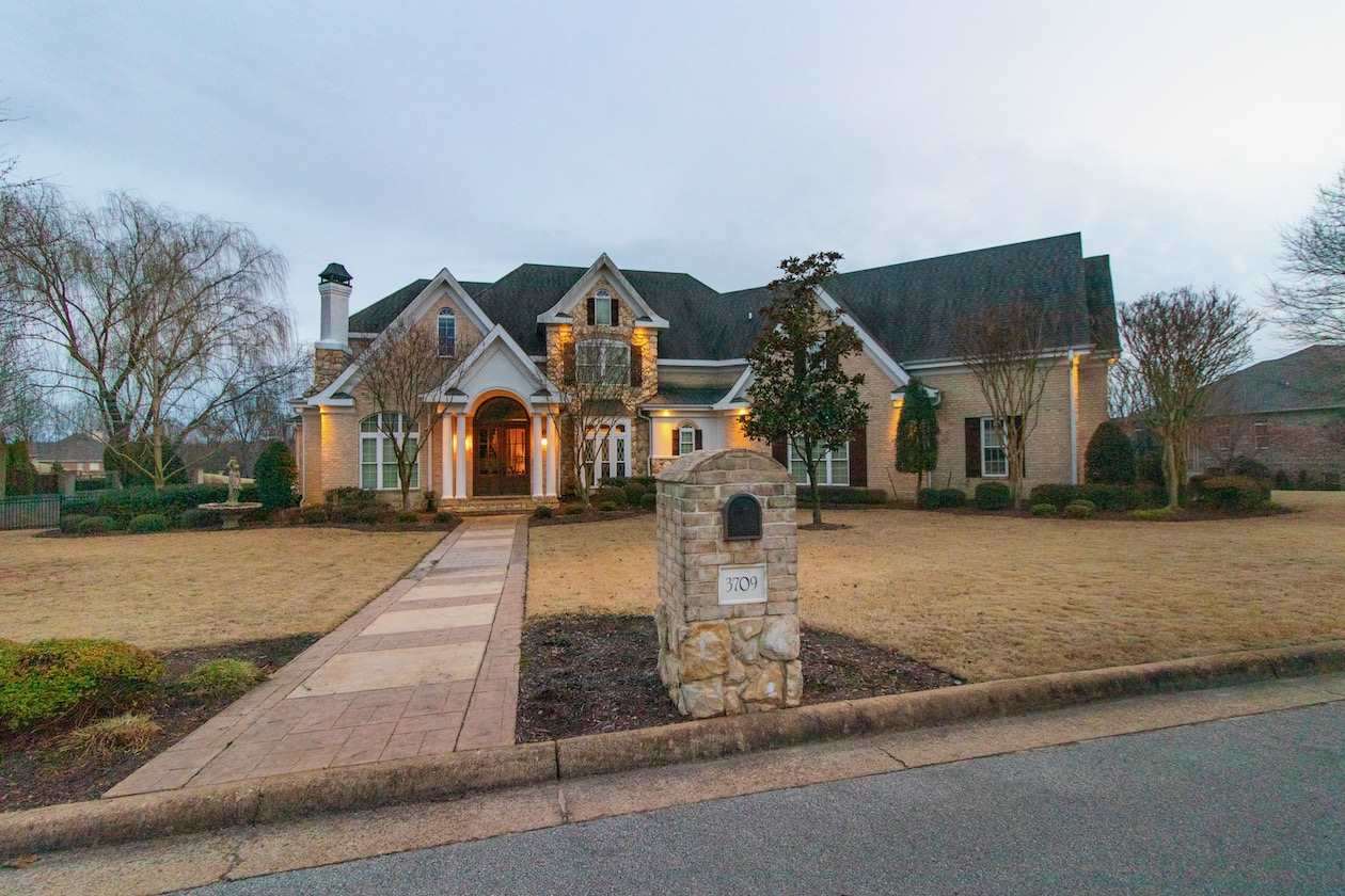 Southern French style custom built with superb quality and the highest standards in material, craftsmanship, and finishes. Distinctive features begin with a heavy wrought iron staircase, stunning amber colored chandeliers, soaring cased windows opening to a stunning view, and notice the carved acorn and oak trim added to the family crest adorning the fireplace mantle in the 2 story living area.