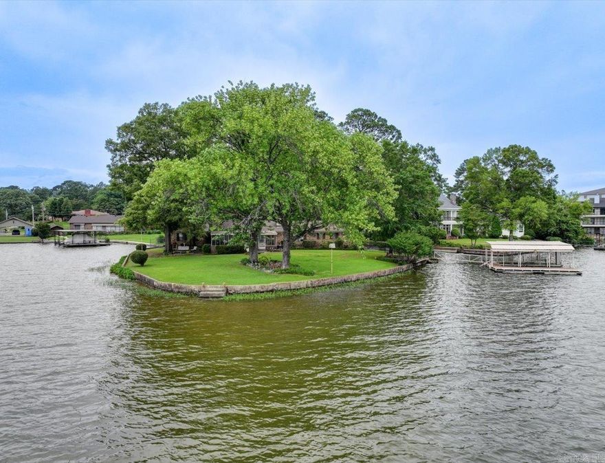 RARE OPPORTUNITY TO OWN A FULL-POINT PROPERTY ON LAKE HAMILTON! Over 465 feet of prime lake frontage with 2 boat slips and dock, on a premium peninsula, with unobstructed, panoramic views in every direction.  Wake up to peaceful sunrises and unwind with vibrant sunsets from your deck, screened-in porch, or boat. Expansive windows throughout the home bring the breathtaking lake views inside, creating a seamless connection with nature.  With a formal living room and spacious family room that opens to a screened-in porch, there’s ample space for entertaining or simply relaxing with family on those perfect lake days.  Whether you’re seeking a vacation retreat, short-term rental investment, or full-time residence, this rare point property offers unmatched peace, privacy, and natural beauty.   Plenty of space to expand, add a pool, outdoor fireplace, or whatever you can imagine.   More than just a lakefront home - here's a chance to own a truly unique piece of real estate where the value lies in the extraordinary land and shoreline - in Lakeside School District. Opportunities like this don’t come often. COME AND SEE!   Agents - please schedule all showings through Showing service.