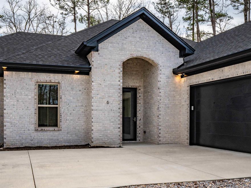 All-Brick New Construction on Cul-de-Sac! Beautiful 3BR/2.5BA home with 2,150 sq. ft. on a level lot less than 2 miles from the East Gate. The open-concept floor plan is filled with natural light and features a cozy gas fireplace. Each bedroom includes its own ensuite. The spacious primary suite offers a tray ceiling, walk-in shower, and a relaxing soaker tub. Quality finishes throughout, including custom blinds, storm doors, remote garage access and a partially floored attic for added storage. Enjoy quiet mornings on the back patio in a peaceful setting. Located near dining, pickleball, tennis, hiking trails, and the beach. Experience the vibrant lifestyle this community has to offer—where comfort meets convenience.  ----See Video Attached to Listing---- Agents see remarks--- Furniture, Washer, Dryer and Security System may be purchased separately---
