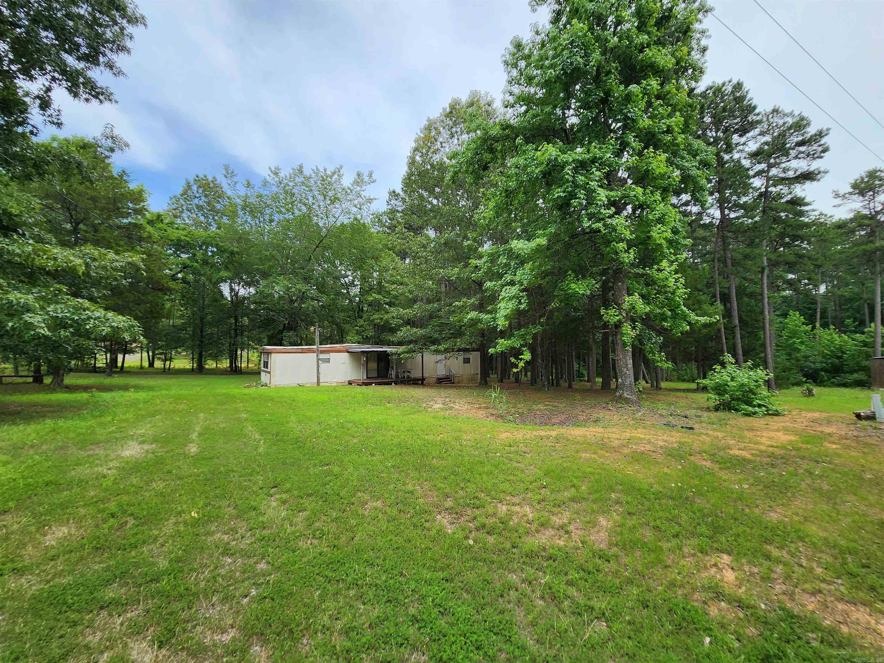 Discover the untapped potential of this expansive 1.7 acres m/l near Greers Ferry Lake. Nestled in a picturesque setting, this offering presents an ideal canvas for those seeking a project. The property boasts a spacious mobile home, although it requires roof repairs and some TLC. Embrace the tranquility of the surroundings, indulge in outdoor activities, and relish the proximity to the lakes, recreational opportunities. Don't miss this chance to acquire an affordable slice of paradise with potential for customization and an enchanting lakeside lifestyle. (see agent remarks)