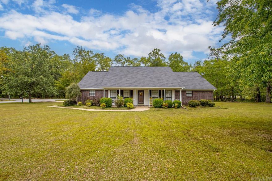 This stunning 3/4 acre property is in Sheridan’s sought-after Brownwood Subdivision and boasts 3 bedrooms, 2.5 baths, and a unique feature - no carpet!  Tile in the living areas and laminate in the bedrooms makes for an easy-to-maintain home!  The spacious kitchen with breakfast area is perfect for entertaining! The living room features a beautiful wood-burning fireplace with hearth, and there is also a formal dining room (currently serving as an office)! The large primary suite is complete with a double vanity, jetted tub, walk-in shower, and two closets! Outside, you’ll find beautiful trees and landscaping, ample parking with 2 carports, a storage building, an insulated shop, and a storm shelter for added peace of mind. New roof installed in 2023 and gutters equipped with gutter guards!