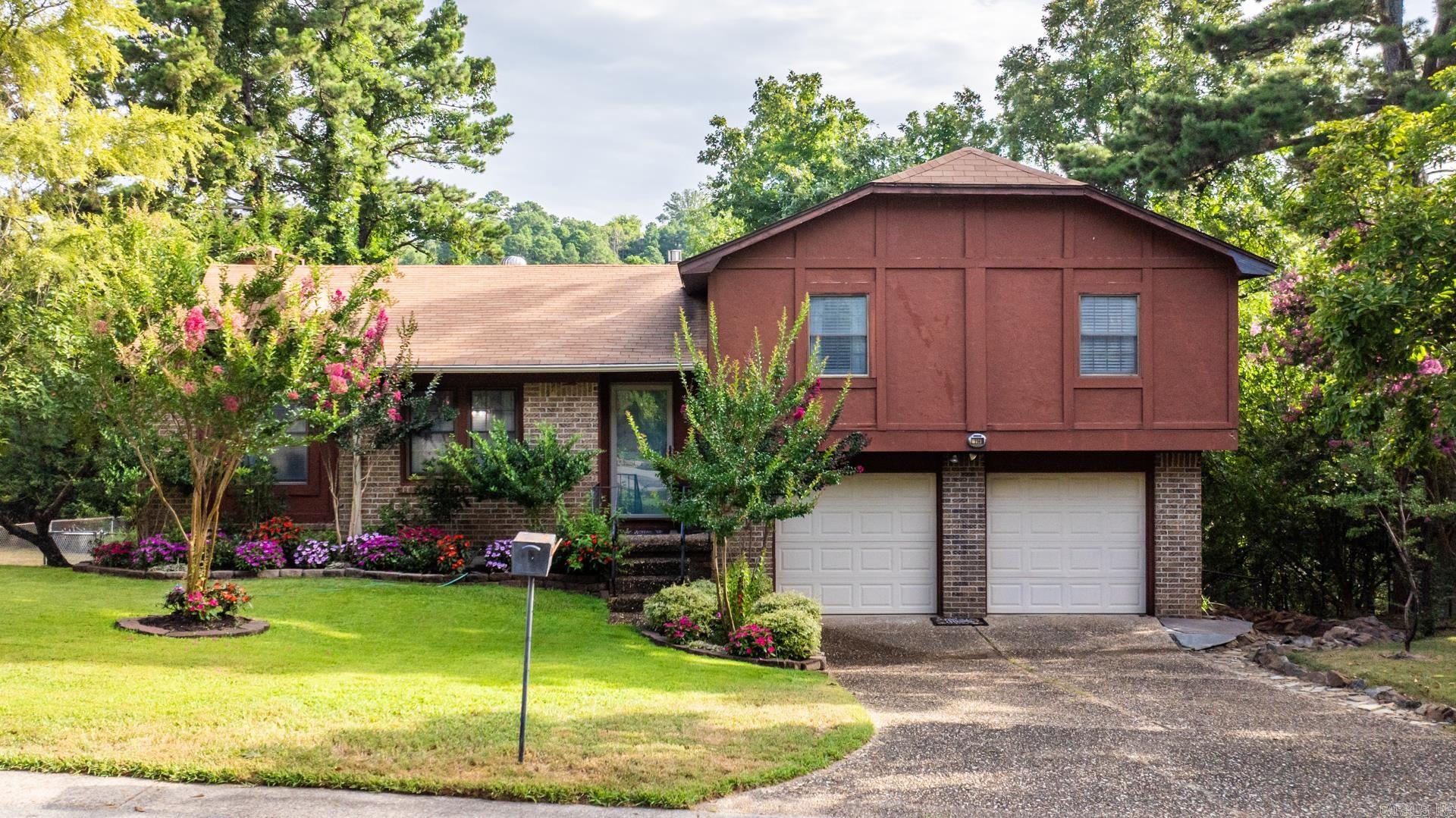 Desiring to live in Little Rock off Cantrell, but dont want to pay steep prices? This is it! This wonderful old home features all the charm you need. A split level plan that features 3 bedrooms and 2 full bathrooms all on the upper level. The living room wraps around into the kitchen/dining area. Giving you an "open concept" feel back from the 70's, but you dont feel closed off. right off the back is a back deck that overlooks the woods in the back with NO rear facing neighbors. This home had the carpet replaced with LVP & newer granite countertops. 2 minutes from the interstate, 7 minutes from downtown & moments from Chenal parkway. A great home to make your own with your special touch! The front yard has been covered with Zoysia grass & tons of beautiful landscaping! There was custom drainage created to right of the home to supply sufficient erosion control and keep water away from the home. Washer, Dryer & Fridge convey.
