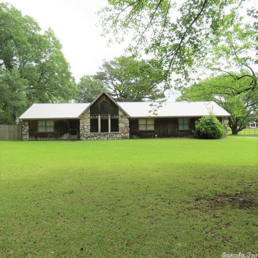 Beautiful Cedar home with vaulted ceilings, large windows, sitting on large lot.  Rock fireplace seperates the living room and dining room.  Split floor plan. Kitchen has large pantry, ss appliances, refrigerator stays.  Stackable washer and dryer stay. Metal Roof.  Back enclosed porch not included in square footage.  This home is ready for a new owner to move in and make it yours!!  Call me today for a personal tour.