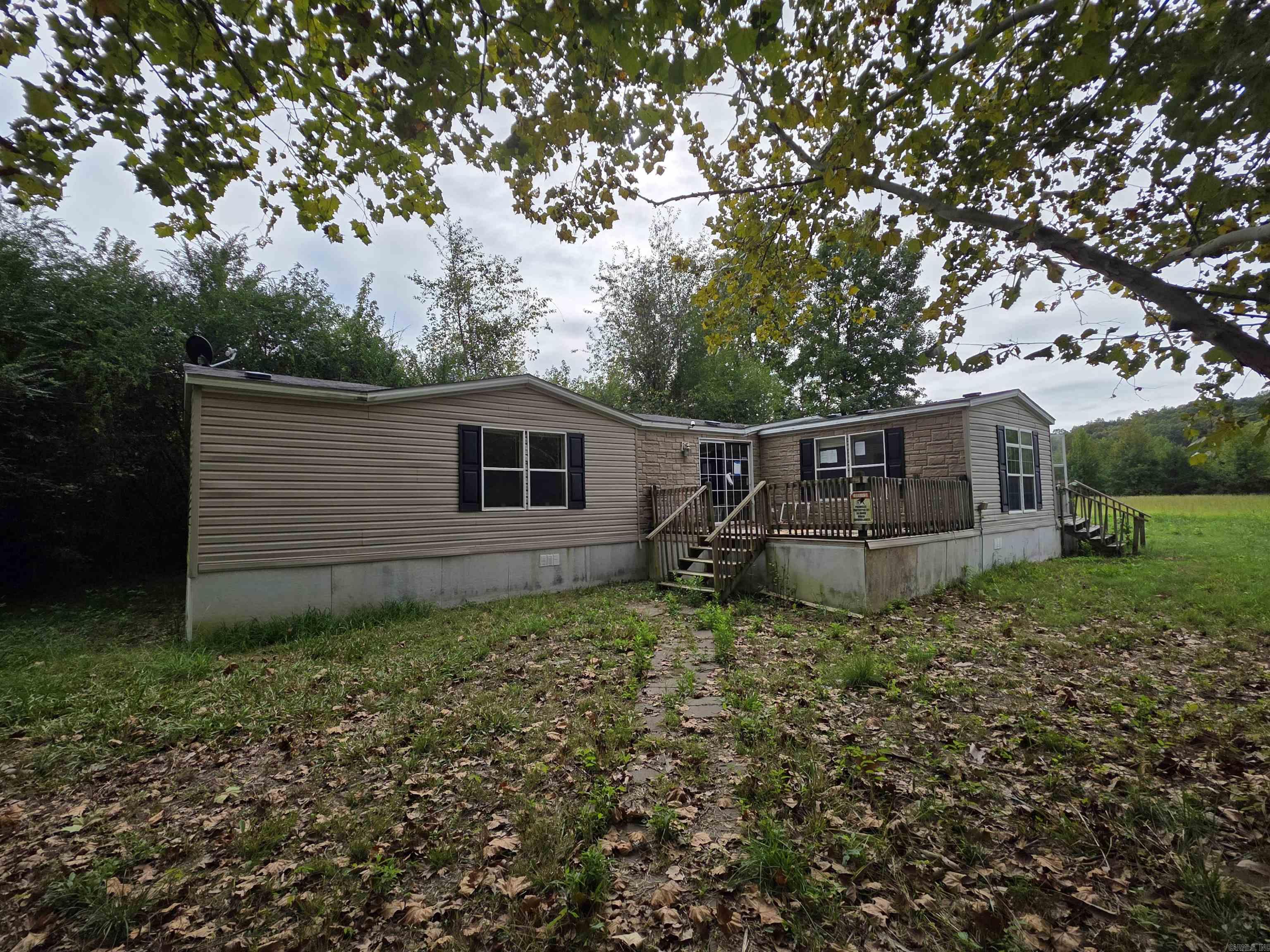 Tucked away on approximately 1.11 acres in the quiet countryside of Vilonia, this 3-bed, 2-bath manufactured home sits on a permanent foundation and offers endless potential. Featuring a split bedroom floorplan, a large open living room, and a spacious kitchen with plenty of cabinet storage, this home is ready for a little TLC to bring it back to life. Surrounded by mature trees and wooded views, the property provides privacy, room to roam, and even includes a storage building. With its peaceful setting and easy access to town conveniences, this could make a great investment, renovation project, or affordable place to call home. Bring your ideas and make this country property shine again! No property disclosure as seller has never occupied the property. Agents see Remarks
