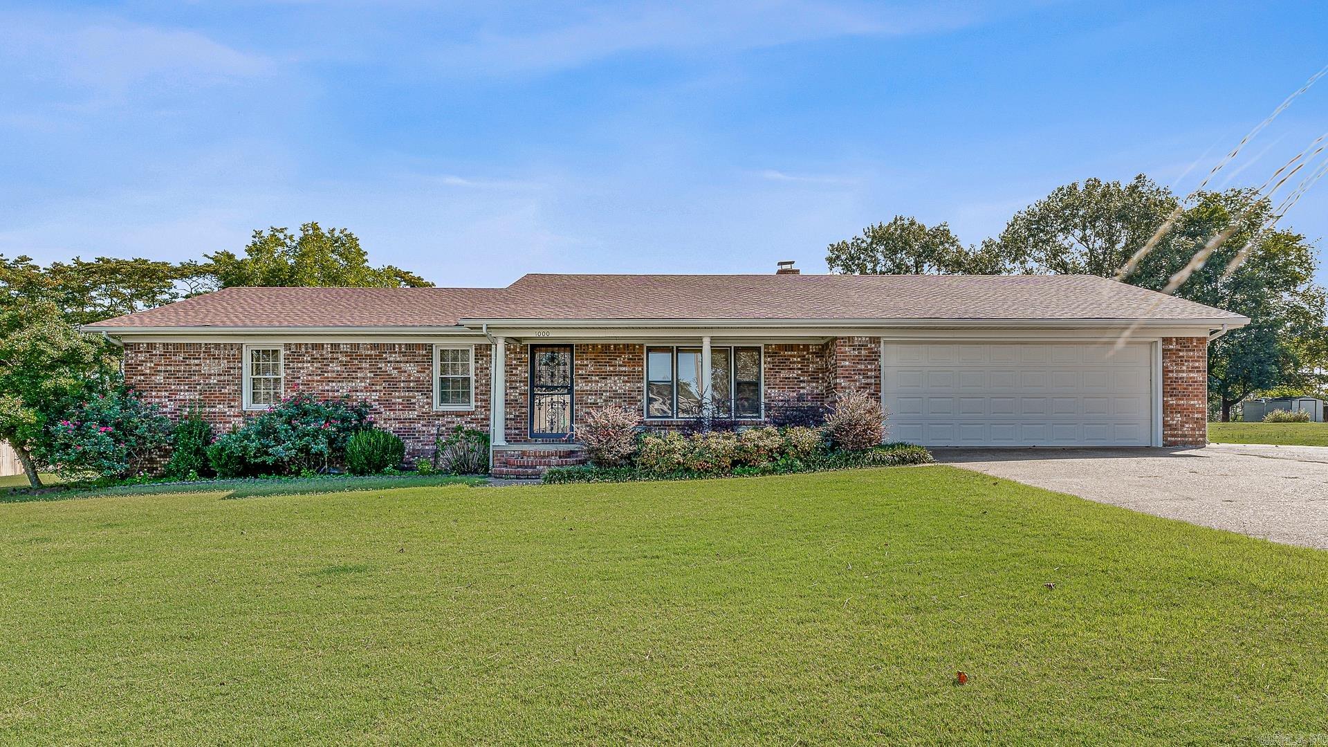 Enjoy the feel of country living right inside the city limits! This charming ranch-style home sits on .58 acre lot with mature landscaping and plenty of outdoor space. Inside, you'll find a large galley kitchen with a breakfast bar, perfect for casual dining and entertaining. The large living area features a beautiful fireplace with a wood-burning insert for those cool evenings. Step outside to a covered back deck overlooking a peaceful backyard complete with a relaxing water feature. A large workshop provides plenty of space for hobbies, storage, or projects. The workshop also has a bay for yard maintenance equipment. At one time water lines were run to the shop and could be easily reconnected. Conveniently located and just minutes from NEA Baptist Hospital, shopping, and restaurants.