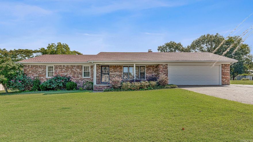 Enjoy the feel of country living right inside the city limits! This charming ranch-style home sits on .58 acre lot with mature landscaping and plenty of outdoor space. Inside, you'll find a large galley kitchen with a breakfast bar, perfect for casual dining and entertaining. The large living area features a beautiful fireplace with a wood-burning insert for those cool evenings. Step outside to a covered back deck overlooking a peaceful backyard complete with a relaxing water feature. A large workshop provides plenty of space for hobbies, storage, or projects. The workshop also has a bay for yard maintenance equipment. At one time water lines were run to the shop and could be easily reconnected. Conveniently located and just minutes from NEA Baptist Hospital, shopping, and restaurants.