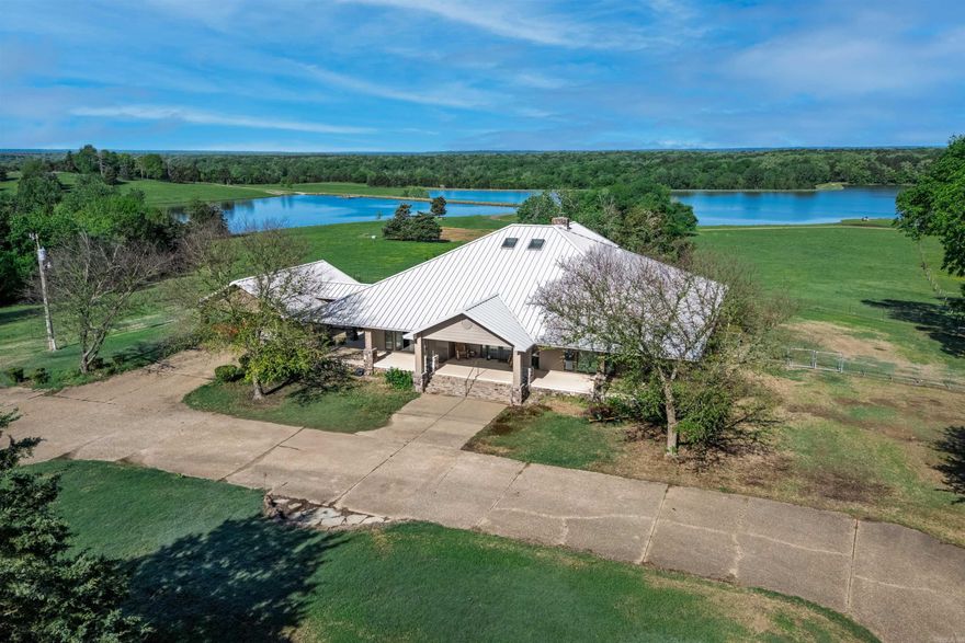 Welcome to an extraordinary legacy property at 211 Hale Rd, Okolona, Arkansas—offering over 545 acres of refined ranch living, recreation, and investment potential. The main residence features 3 bedrooms,  baths, an open-concept layout with soaring ceilings, a striking stone fireplace, granite countertops, custom cabinetry, and durable stained concrete floors, plus a fenced backyard. A well-appointed 2 bed, 2 bath guest house showcases abundant windows, natural light, lake views, and a cozy fireplace, creating a private retreat for guests or family. The property is fully equipped for livestock and equestrian use with a top-tier horse barn, custom cattle working pens, and four fenced grazing pastures. A large shop includes an office, full bath, and kitchen-equipped breakroom. The breathtaking 60-acre private lake, designed with Corps of Engineers influence, features a concrete boat ramp and multiple docks, alongside a second stocked pond. A rare blend of luxury, functionality, and natural beauty. Agents see agent remarks.