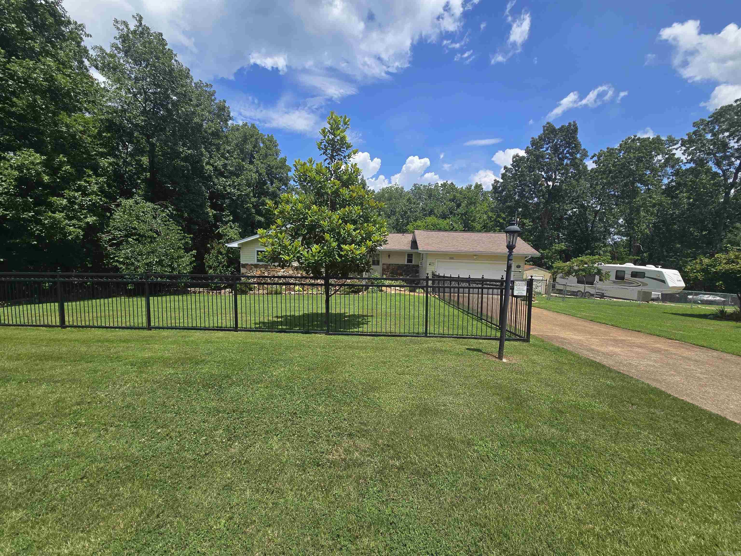 Immaculate 2 bed, 2 bath home on 1.75 AC M/L with seasonal views of Crown Lake. This beautifully maintained home features vaulted ceilings, LVT flooring, energy-efficient 2x6 walls, replaced roof 2023, new windows, and fresh paint throughout. The updated kitchen includes all-newer stainless appliances, including an induction cooktop, and a convection oven. The spacious heated/cooled sunroom offers stunning views of the rock-landscaped backyard and Crown Lake. The primary bedroom includes custom built-ins in the walk-in closet. Additional features include a large pantry, extra storage in the crawlspace, a basement workshop (could be used as a den), and a 50 amp RV hookup. Two sections of the yard are fully fenced, with separate areas for front and back. Lake access is just down the main road. Storm shelter in the garage and a general automatic whole house generator convey. Listed at $275,000.
