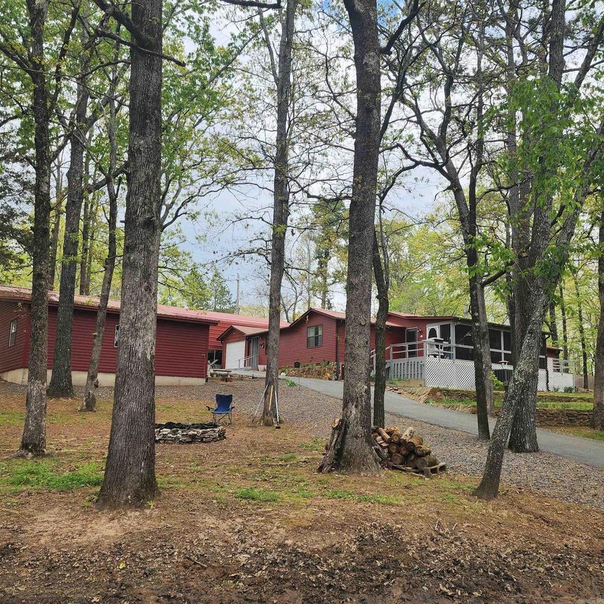 Welcome to your perfect lake escape or full-time residence! This charming 3-bedroom, 2-bath home sits on a shady corner lot just 3 minutes from Ferguson Choctaw Marina and only 1 minute from a convenient boat launch on the stunning Greers Ferry Lake. Enjoy laid-back lake living with plenty of space for all your toys and guests—featuring an attached garage, a metal carport, an RV carport, and a detached garage. Part of the detached garage has already been converted into sleeping quarters—ideal for visitors or perfect for finishing out into a separate guest suite or potential Airbnb with a bathroom addition. Step inside to a warm and welcoming interior with wood burning stove, mud room, some fresh updates including new flooring, fresh paint, and a relaxing new soaking tub in the 2nd bath & outdoor sink. The screened-in front porch is the perfect spot to unwind after a day on the water. Whether you're looking for a peaceful weekend getaway or your next full-time home, this property has everything you need to live the lake life. Don’t miss your chance to own this versatile and cozy home near one of Arkansas' most beautiful lakes! Come see it today and start living your lake life dream!