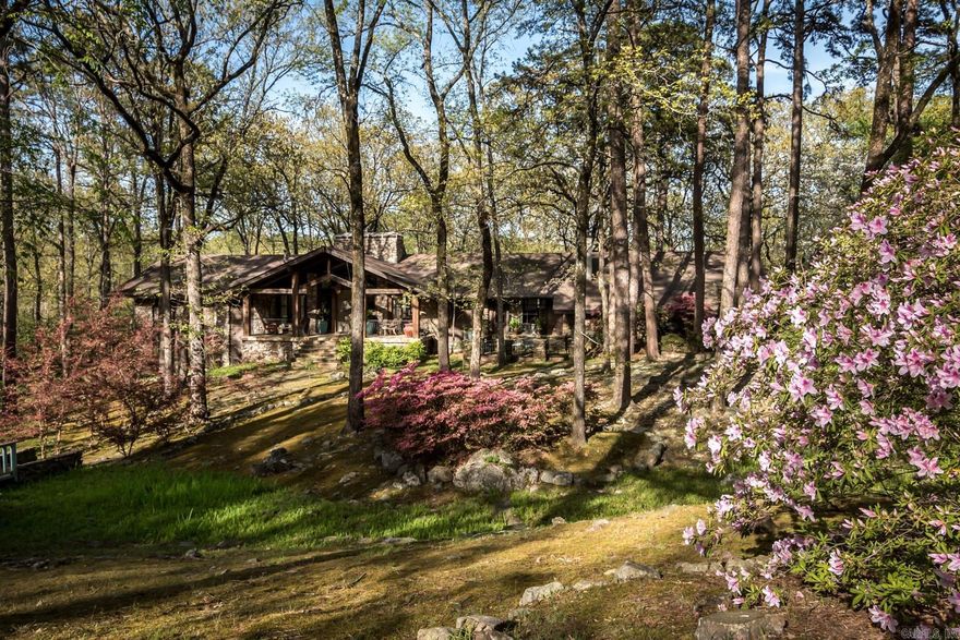 Positioned on 1.13 acres, centered on two lots, this residence offers beautiful views of the Pleasant Valley Golf Course while maintaining a private setting surrounded by nature. The home home and grounds maximize the natural beautify of its surroundings with a feeling of seclusion and tranquility rarely found in a traditional neighborhood setting. The spacious great room features a stunning stone wall fireplace, vaulted ceilings with reclaimed wooden beams, and reclaimed Hickory hardwood floors. A chef's gourmet kitchen awaits, complete with a large island with a distressed finish, granite countertops, apron front copper sink and handcrafted cabinetry, alongside top-of-the-line appliances including a Sub-Zero refrigerator and freezer, Thermador gas range and a custom vent hood.  The cozy hearth room, adorned with an adobe-walled fireplace and half bath provides a perfect retreat for intimate gatherings. Primary bedroom suite boasts vaulted ceilings, exposed wooden beams and a spa-like bathroom. The lower level offers a multi-purpose gathering room, office/exercise room, kitchen, laundry service, three bedrooms and two bathrooms.  Oversized two-car garage plus golf cart garage.