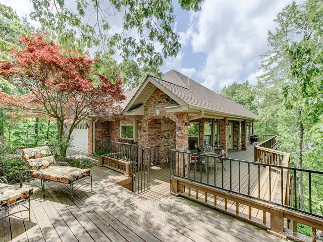 AGENTS, PLEASE CONTINUE TO SHOW, BUYERS HAVE A HOME TO SELL. NEARLY 700' OF EXTREMELY DESIRABLE PRIME LAKE FRONT PROPERTY! Surrounded by water on 3 sides this property is perfectly private and cradled in one of the most spectacular views you can imagine. You will enjoy multiple decks with incredible lake and mountain views, beautiful sunsets and year round gardens. This home is architecturally designed to capture natures natural sunlight in every room. Gourmet Chef's kitchen with designer granite, double ovens, walk in pantry, gas range & Monogram appliances. Master shower is also a sauna Stunning views of the lake and year round gardens. Outdoor shed with workshop. Lower level provided 3 guest rooms and a huge entertaining area with pool table and lower deck. Step outside and you will enjoy manicured lawns surrounded by a beautifully fenced area specially created for children and pets, of course with beautiful views! Down to the boat dock and away you go...Fishing, Boating, Jet Skiing...this lake was made for FUN! Furnishings negatable...