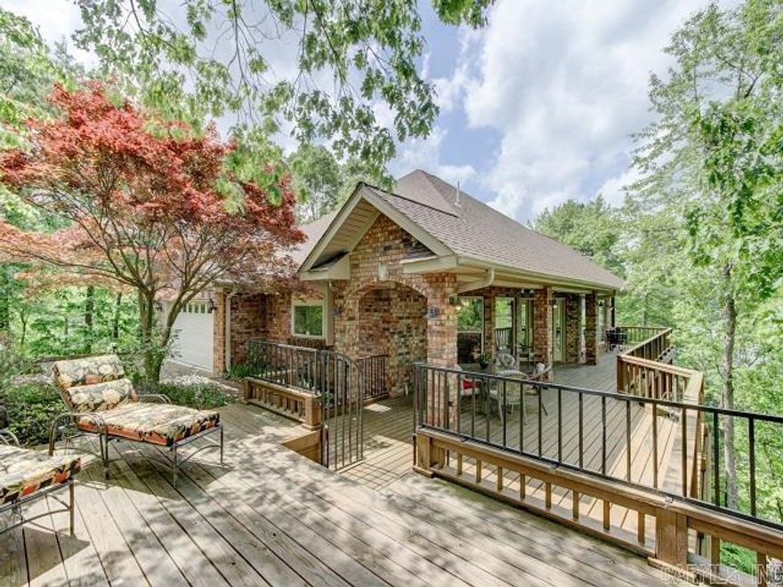 AGENTS, PLEASE CONTINUE TO SHOW, BUYERS HAVE A HOME TO SELL. NEARLY 700' OF EXTREMELY DESIRABLE PRIME LAKE FRONT PROPERTY! Surrounded by water on 3 sides this property is perfectly private and cradled in one of the most spectacular views you can imagine.  You will enjoy multiple decks with incredible lake and mountain views, beautiful sunsets and year round gardens. This home is architecturally designed to capture natures natural sunlight in every room. Gourmet Chef's kitchen with designer granite, double ovens, walk in pantry, gas range & Monogram appliances. Master shower is also a sauna Stunning views of the lake and year round gardens. Outdoor shed with workshop. Lower level provided 3 guest rooms and a huge entertaining area with pool table and lower deck.  Step outside and you will enjoy manicured lawns surrounded by a beautifully fenced area specially created for children and pets, of course with beautiful views! Down to the boat dock and away you go...Fishing, Boating, Jet Skiing...this lake was made for FUN! Furnishings negatable...