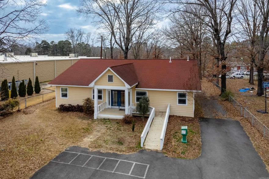 High-Visibility Commercial Opportunity on Hwy 365! Positioned just off I-40, this well-located commercial/retail office offers outstanding visibility and easy access in a high-traffic corridor. A prominent sign out front provides excellent exposure to approx 9,400 daily vehicles passing through Mayflower Highway 365**. The building features paved parking out front and a functional, interior layout. Inside, there’s a reception area, a full kitchen, a dining area, two half bathrooms, and five private offices.  Additional covered parking is located behind the building for added convenience. In addition to the office space, the property includes a large shop with a garage door, ideal for storage, workspace, or light industrial use. More land in the back allows for expansion opportunities. This property is sold as is, no disclosures. There are areas of the handicap access ramp needing TLC. The shop needs repairs, but it has electricity and plumbing. This property is ideal for professional services, contractors, small business headquarters, or investors seeking a versatile commercial asset with strong visibility and growth potential.