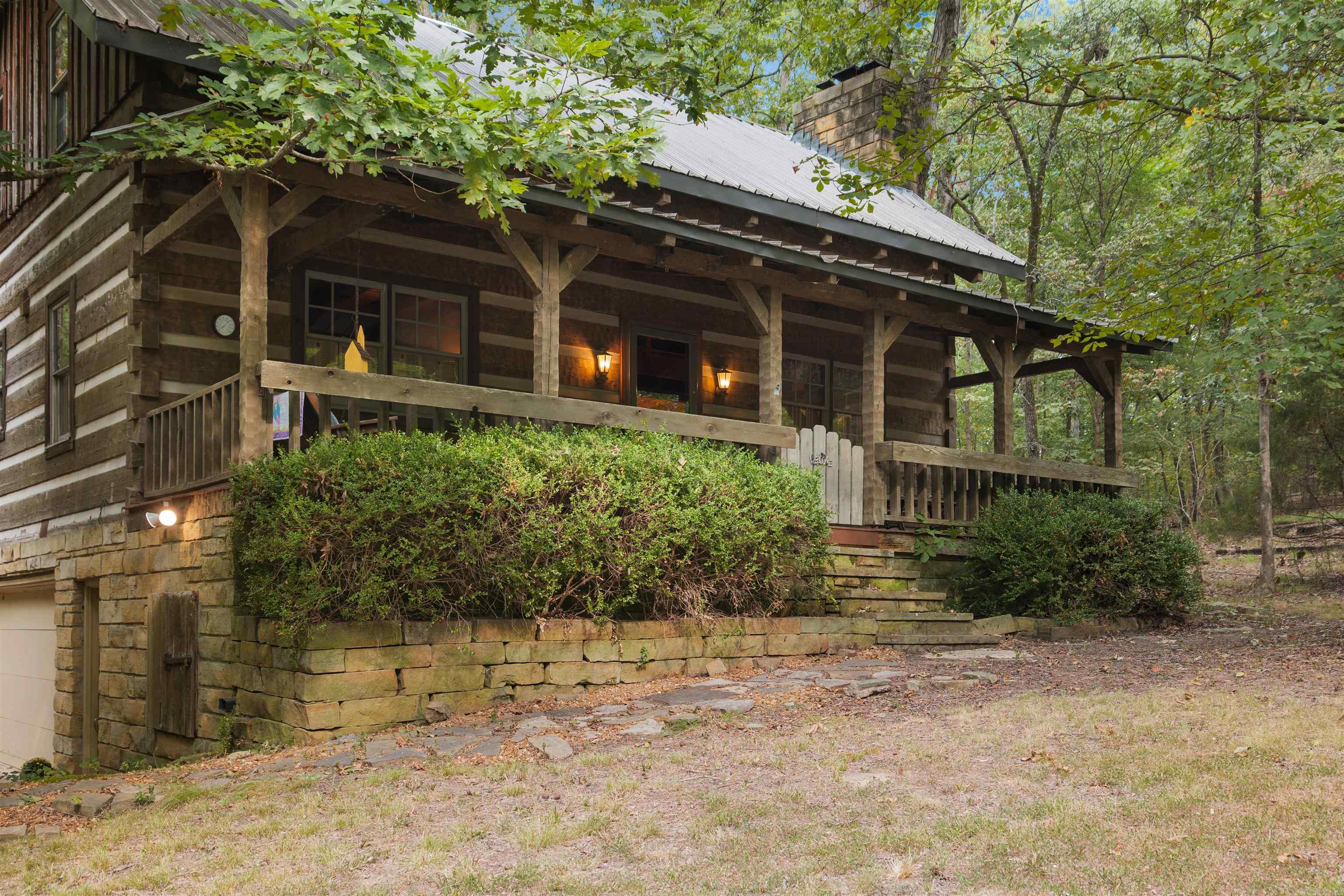 One of very few like this one in Jonesboro! Authentic hewn log home on 0.76 of an acre. The log construction is of 6'x12' pine logs with steel trusses. Interior walls constructed of reclaimed barn wood, as well as the kitchen cabinets. The upper bathroom features antique water closet style toilet, clawfoot tub and pedestal sink dated to the 1920's. The home has a steel roof with new skylight. Located within a short walk to Craighead Forest Park! This home features large front and rear porches perfect for sitting out having your morning coffee. Two bedrooms, two baths, laundry, kitchen with dining room, beautiful family room with limestone fireplace. Interior floors are solid pine with ceramic tiles in the bathrooms. The upper level includes a loft overlooking the family room, which could also be used for additional sleeping area or office space. The opportunities are endless for this beautiful property.